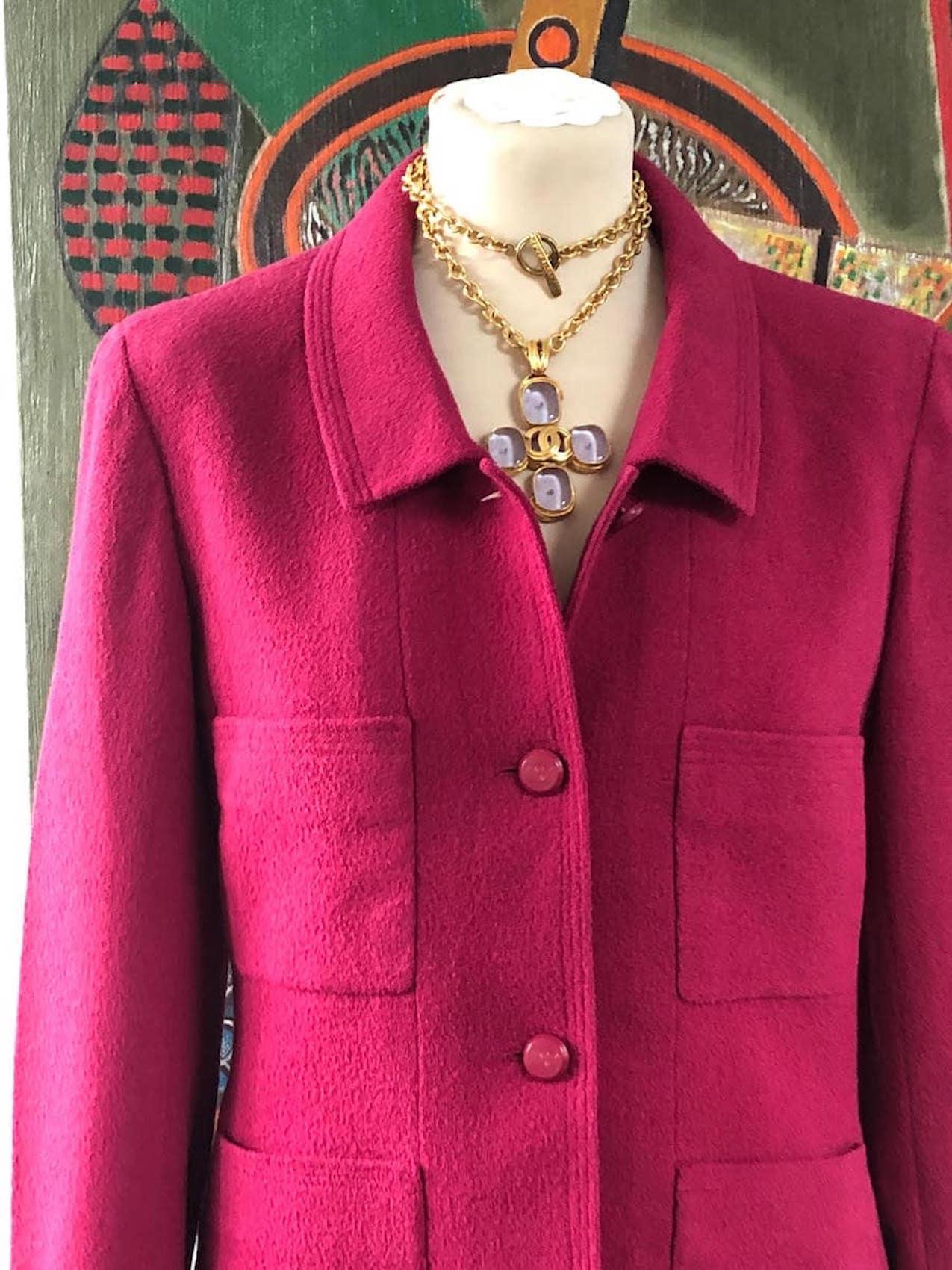 CHANEL 1998 Wool Jacket Tweed Skirt Suit Pink CC Logo Buttons
A classic stunning vintage Chanel in dark pink, wool bouclé suit skirt and jacket from Autumn 1998 collection. The two-piece set is detailed with CC-logo embossed buttons (the buttons