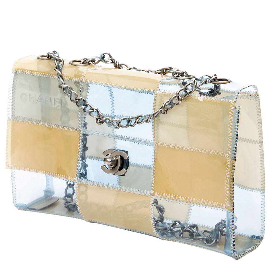Embrace contemporary style with a vintage twist with thist Chanel 1999 Limited Edition Patchwork PVC Classic Flap Bag. The beige and blue PVC patchwork exterior is accented by silver-tone hardware and a CC turnlock closure. Inside, the PVC-lined