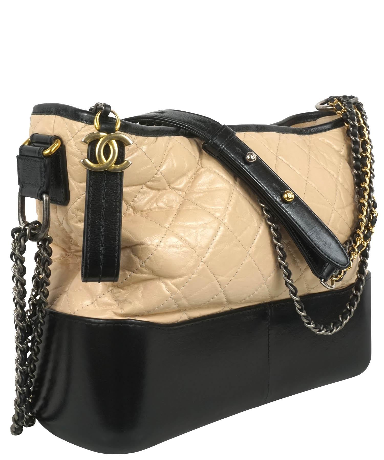 Chanel medium Gabrielle bag, from their 2018 Autumn Collection. Bag has beige quilted aged calfskin leather with a smooth black leather bottom and matching black leather accents. Bag strap has three mixed metal black leather wrapped straps, has a