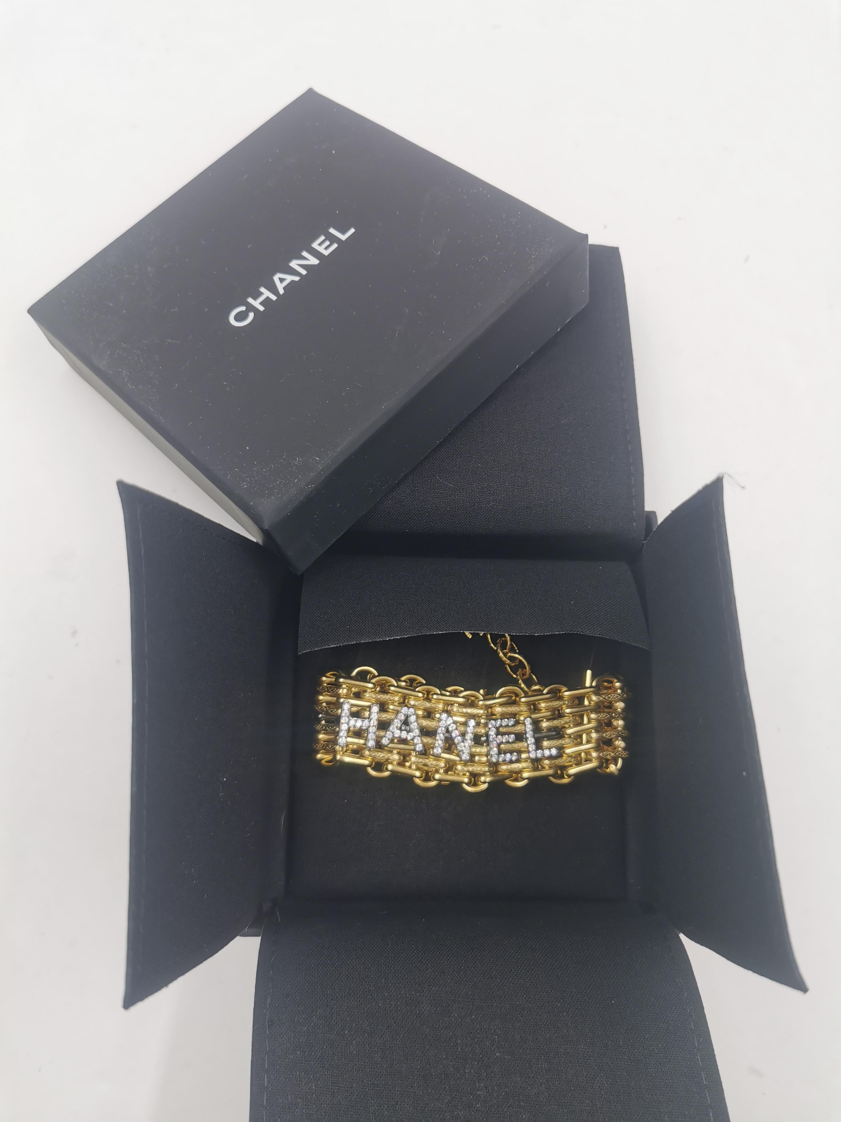 Introducing the exquisite Chanel 20 Runway Alphabet Gold LARGE Massive Rhinestone Chain Bracelet. This stunning piece of jewelry is a true embodiment of luxury and style, showcasing Chanel's unparalleled craftsmanship and attention to