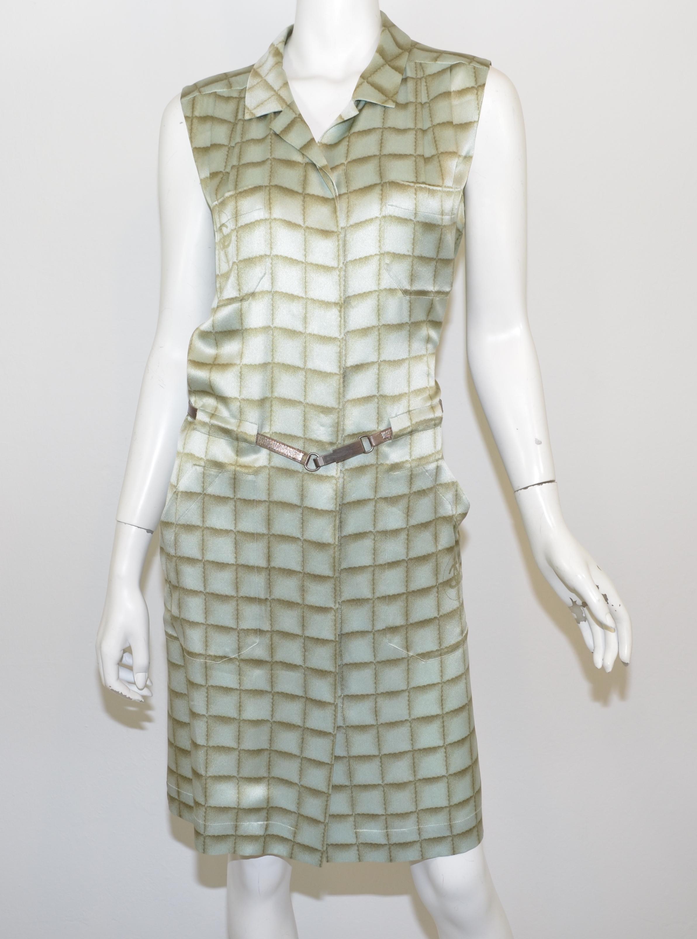 Chanel 2000 A dress is featured in mint green with a brown grid pattern throughout, concealed button closures with a drop-waist design and a clip belt. Dress has pockets at the bust and hips.

Measurements:
Bust 38”
Waist 36”
Hips 42”
Length