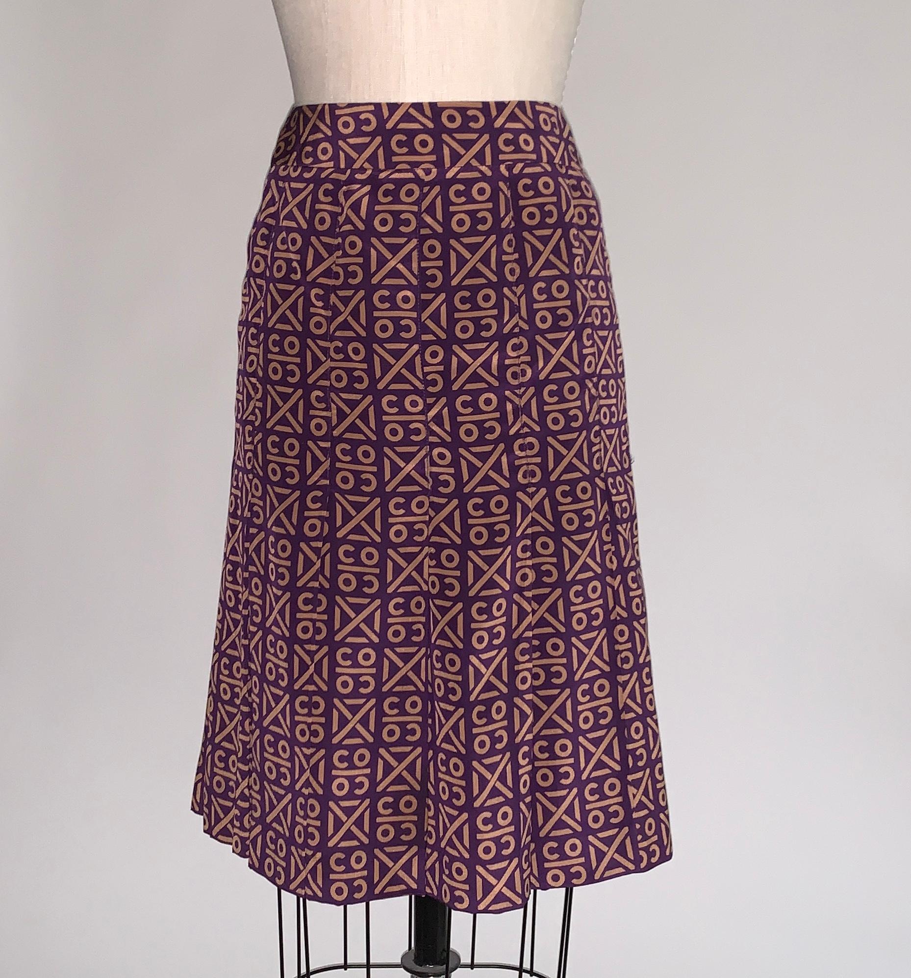 Chanel purple and tan pleated skirt from the Autumn 2000 collection. As seen in look 32 of the fashion show (or very similar.) Geometric Coco print throughout. Shell buttons at back stamped Chanel Paris Back zip, snap and button closure.

100%