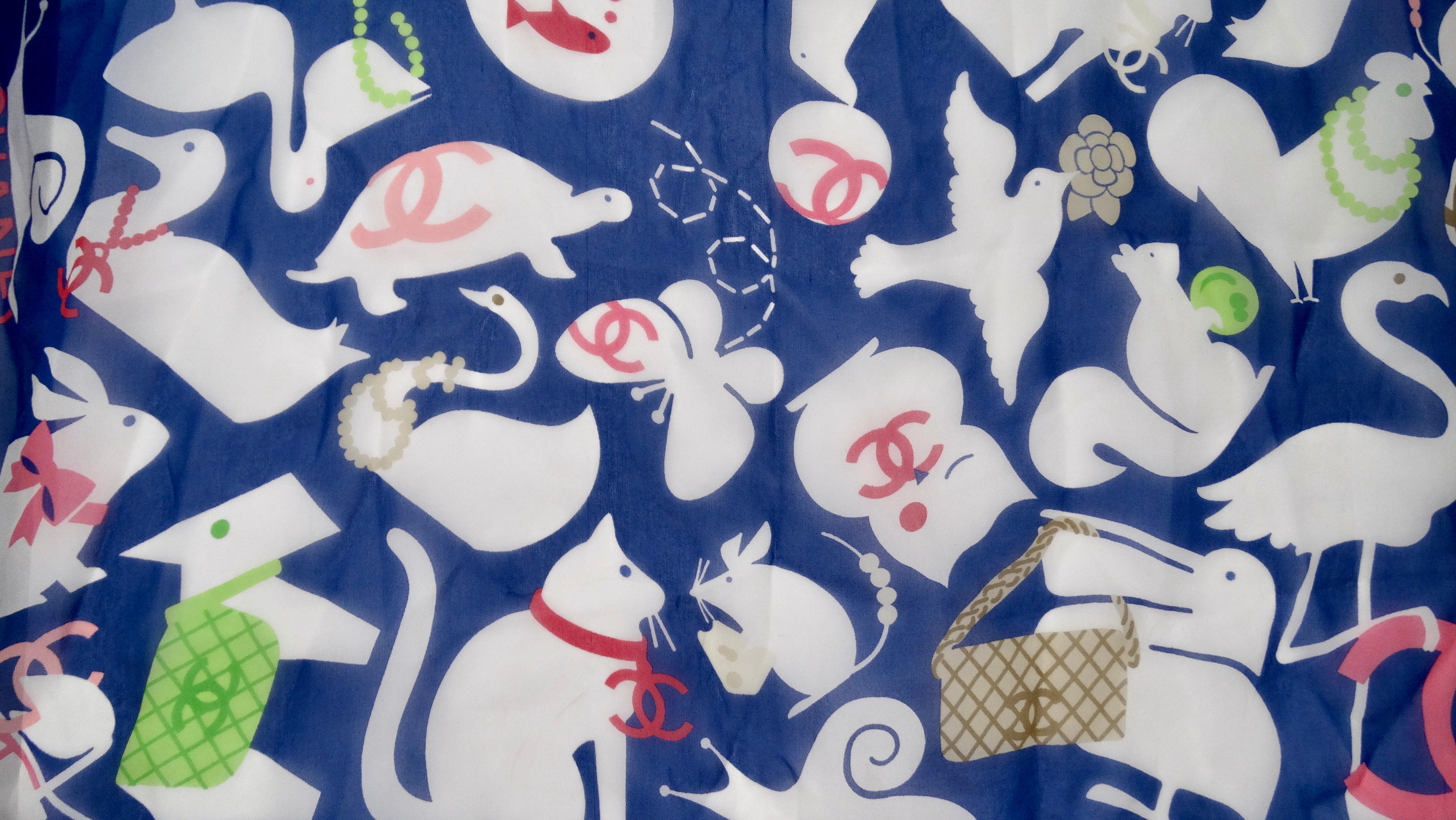 Add this adorable Chanel to your collection! Circa 2005/2006, this Silk blue scarf features a charming motif of baby animals complete with colorful accents and the signature CC logo with 'Chanel' in pink font. The perfect addition to all your