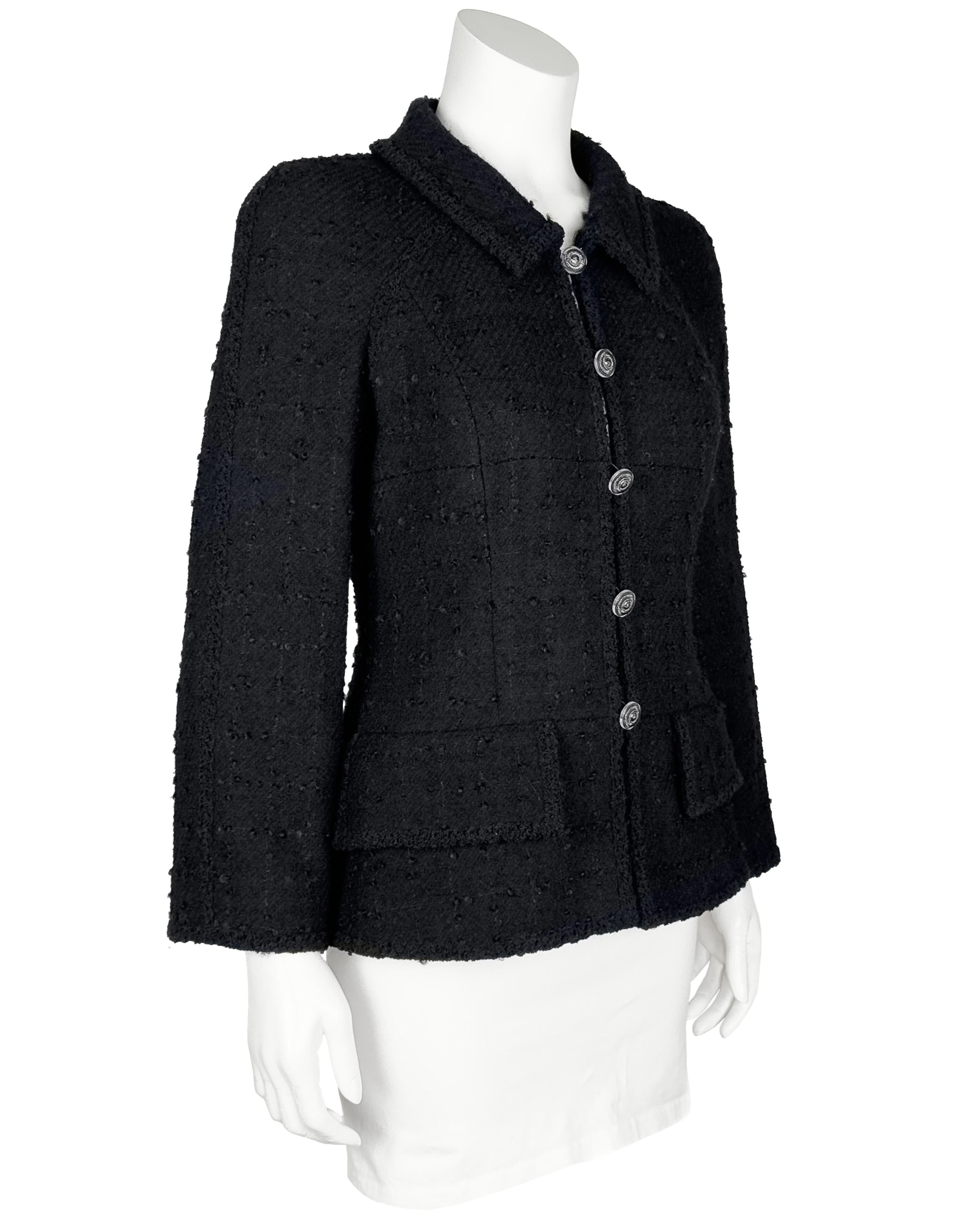 CHANEL 2000'S  era black textured bouclé wool and mohair 2 pocket fitted jacket with silk lining and silver tone and clear resin buttons. Fitted through the waist with a small collar and two flap pockets. Five buttons up the front. Angular should