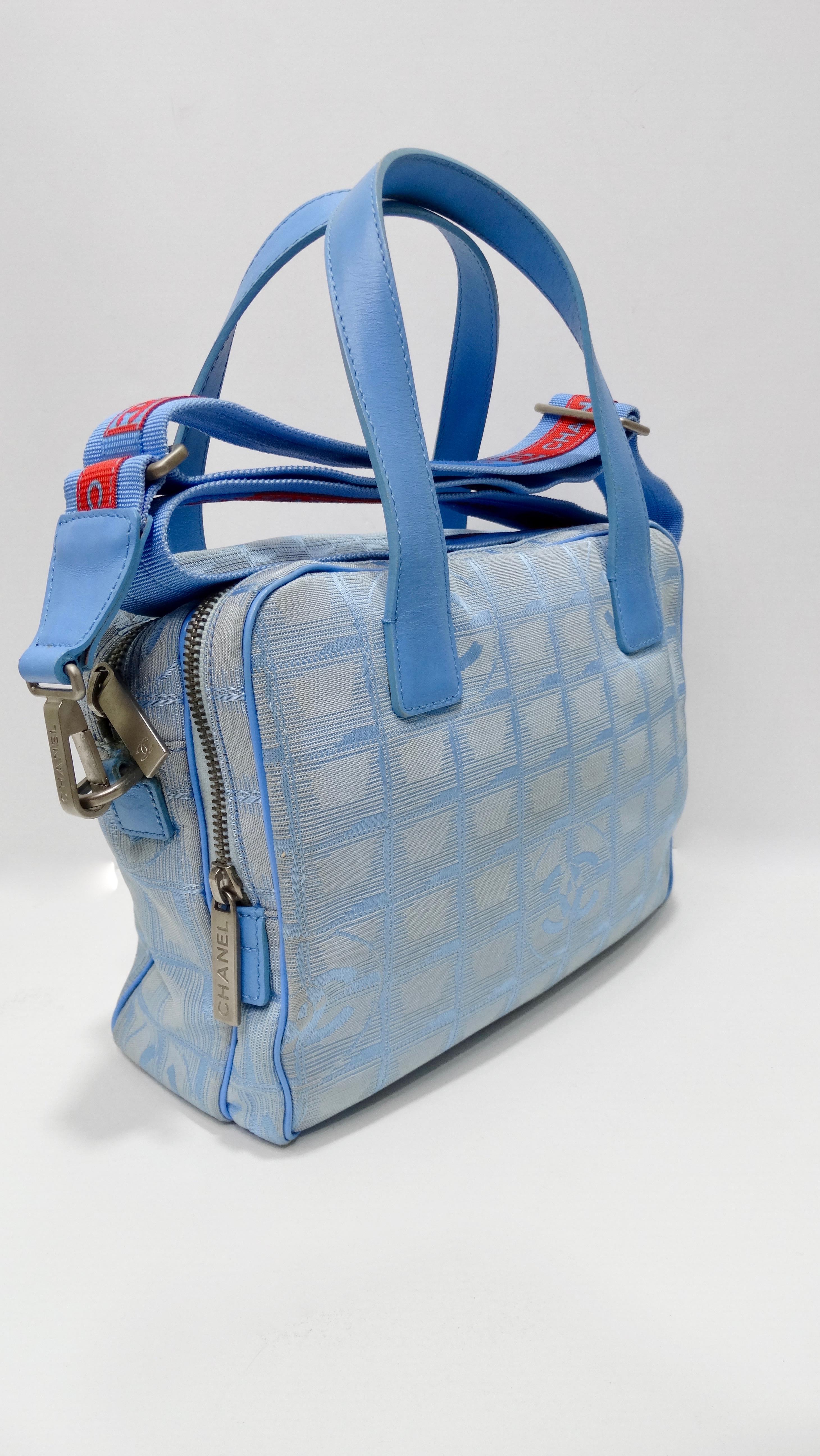 Calling all the Chanel lovers! Circa 2001-2003, this travel line Chanel mini tote is crafted from two-tone blue canvas and features a grid pattern with CC's. Includes blue leather piping, silver hardware, dual blue leather top handles, two top