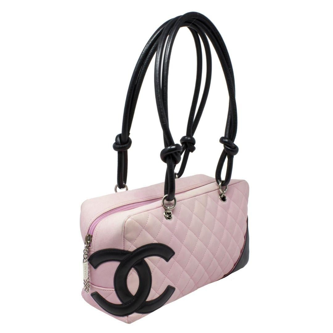 Major Y2K vibes! From 2003, in a gorgeous pink quilted leather with a large black CC logo, with silver-tone hardware and dual rolled black handles. There is a pocket on the outside and protective feet at the base. The zipper pull is a gorgeous