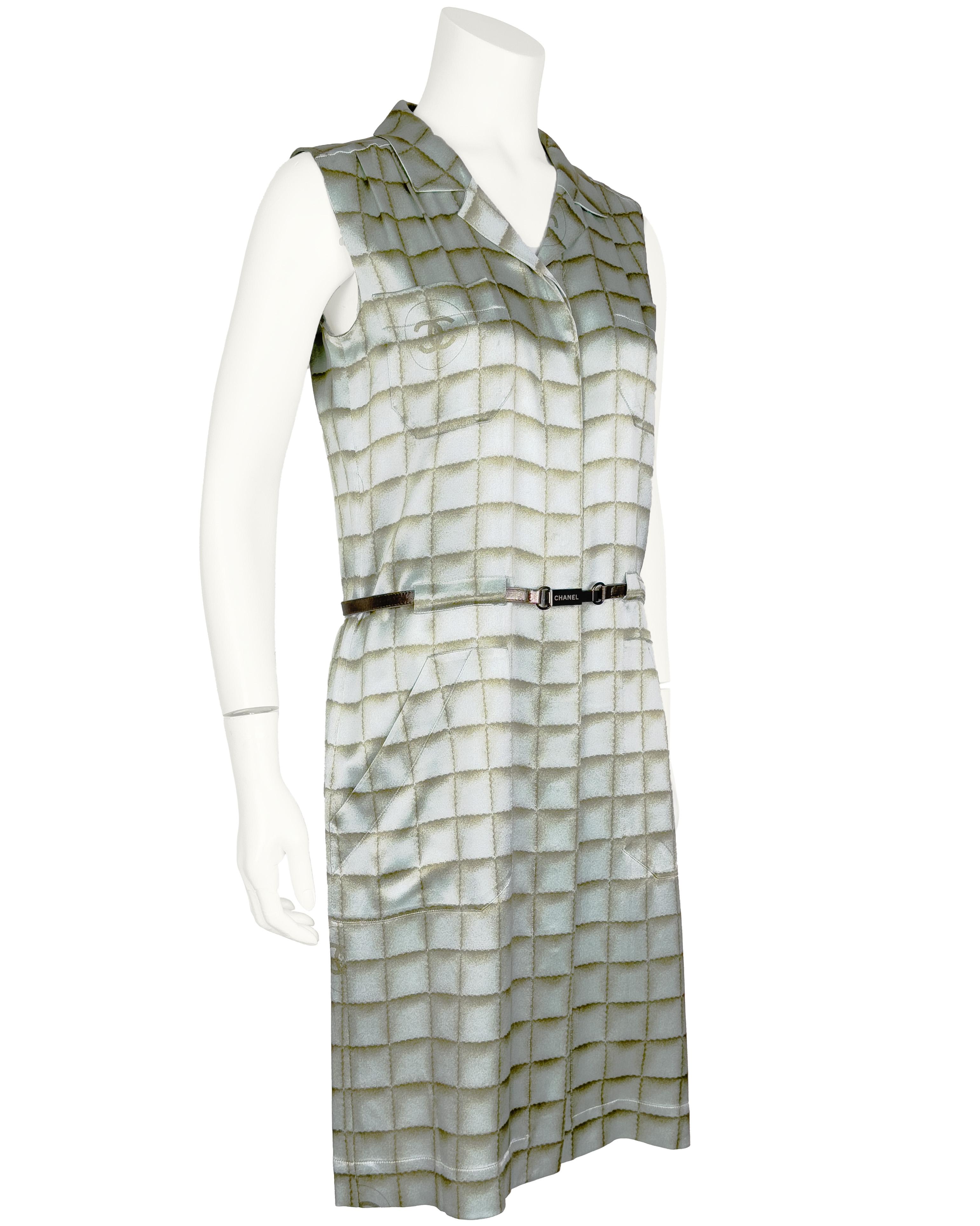 Chanel early 2000's sleeveless mint green silk/satin day dress . Hidden under placket button front with notched collar. Narrow leather belt set at waist inside belt loops. CC logo printed in the checkerboard fabric appears on the back of the neck,