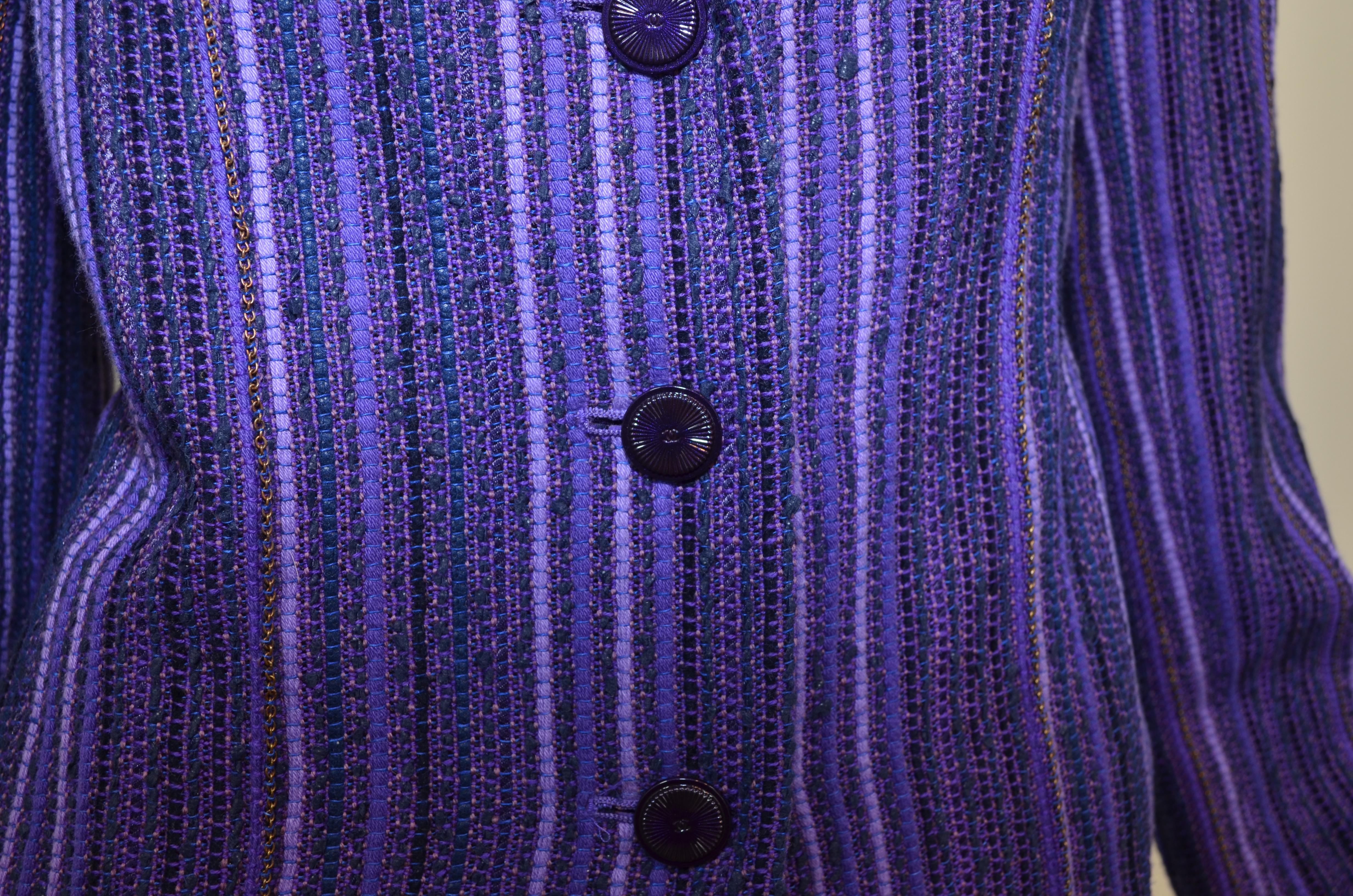 Chanel 2001 P Tweed Jacket featured in a purple tweed fabric with chains and button fastenings. Jacket is labeled size 44, made in France.

Measurements:
Bust - 42''
Sleeves - 24''
Shoulders - 16''
Length - 28''