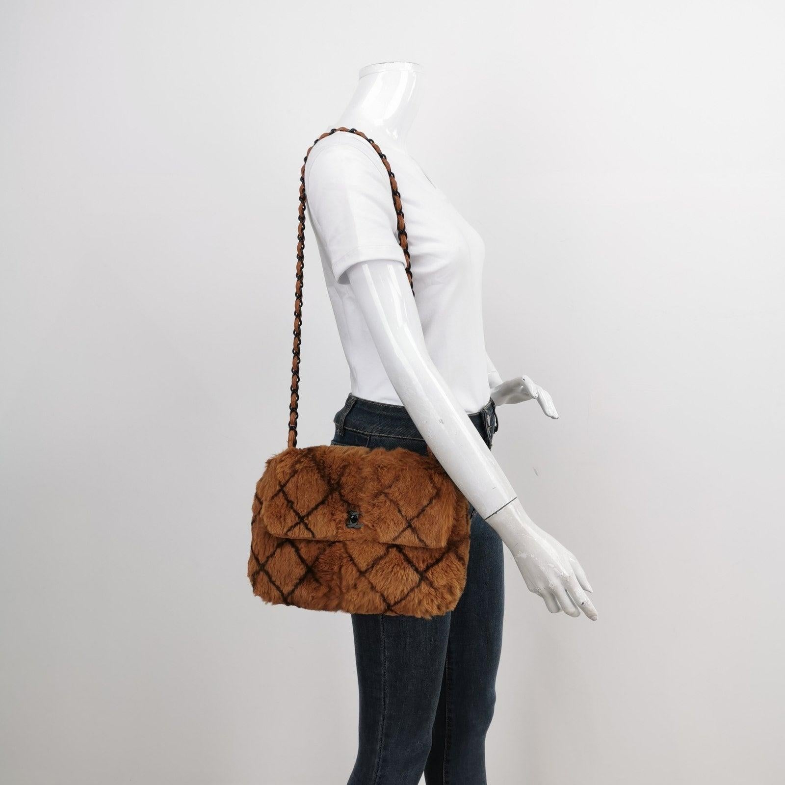 Chanel 2002 Brown Lapan Rabbit Fur Vintage Flap Bag These are professional photos of the actual bag offered by Luxbags. Elevate your winter style with the Chanel Lapan Rabbit Fur Vintage Flap Bag. This vintage classic is adorned with a large diamond