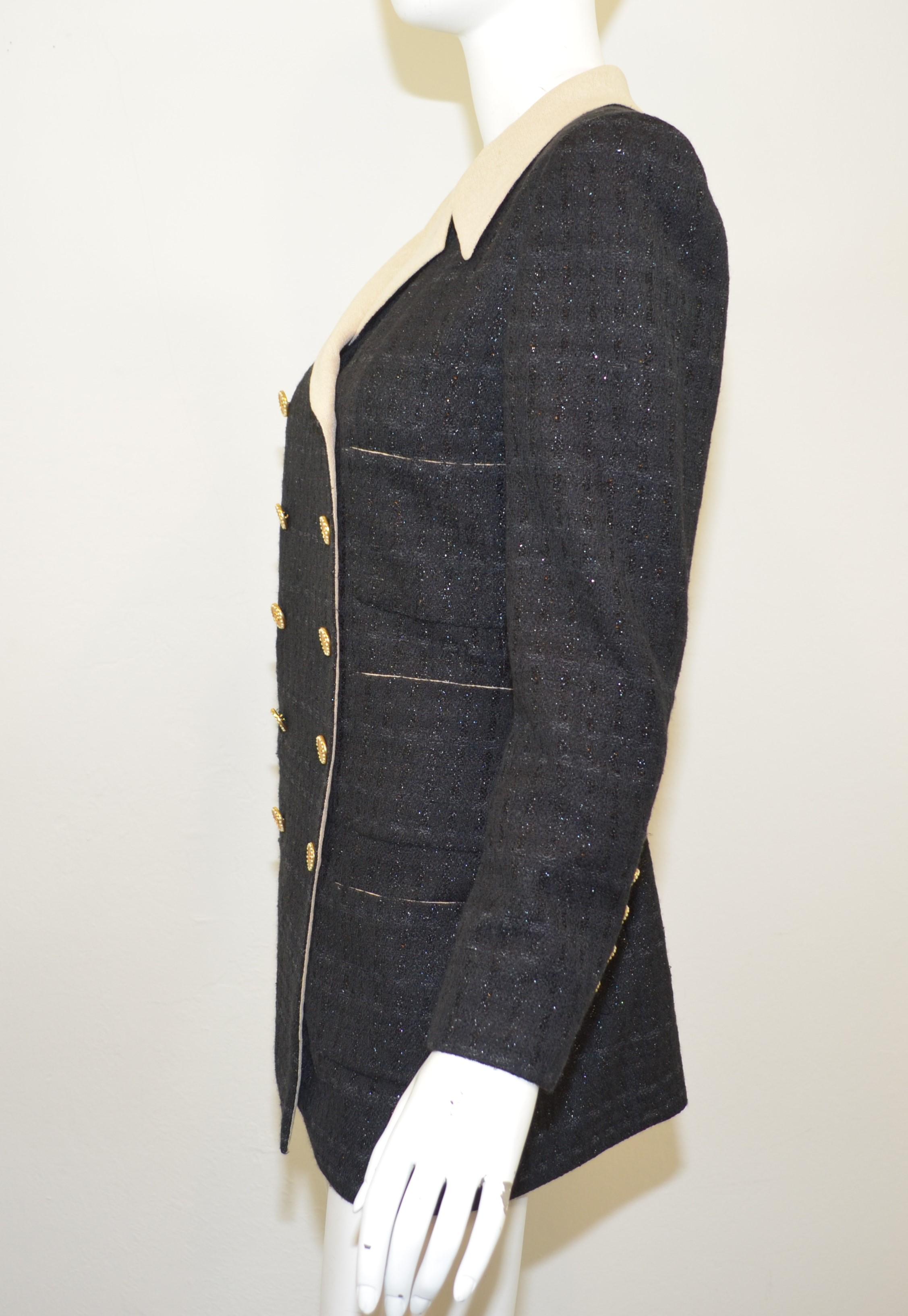 Chanel jacket from 2002 P collection is featured in a dark navy with a shimmered finish and gold-tone buttons encrusted with pearls. Jacket is fully lined and has a total of four patch pockets. Jacket is a size 40, made in France.

Bust 38''
Sleeves