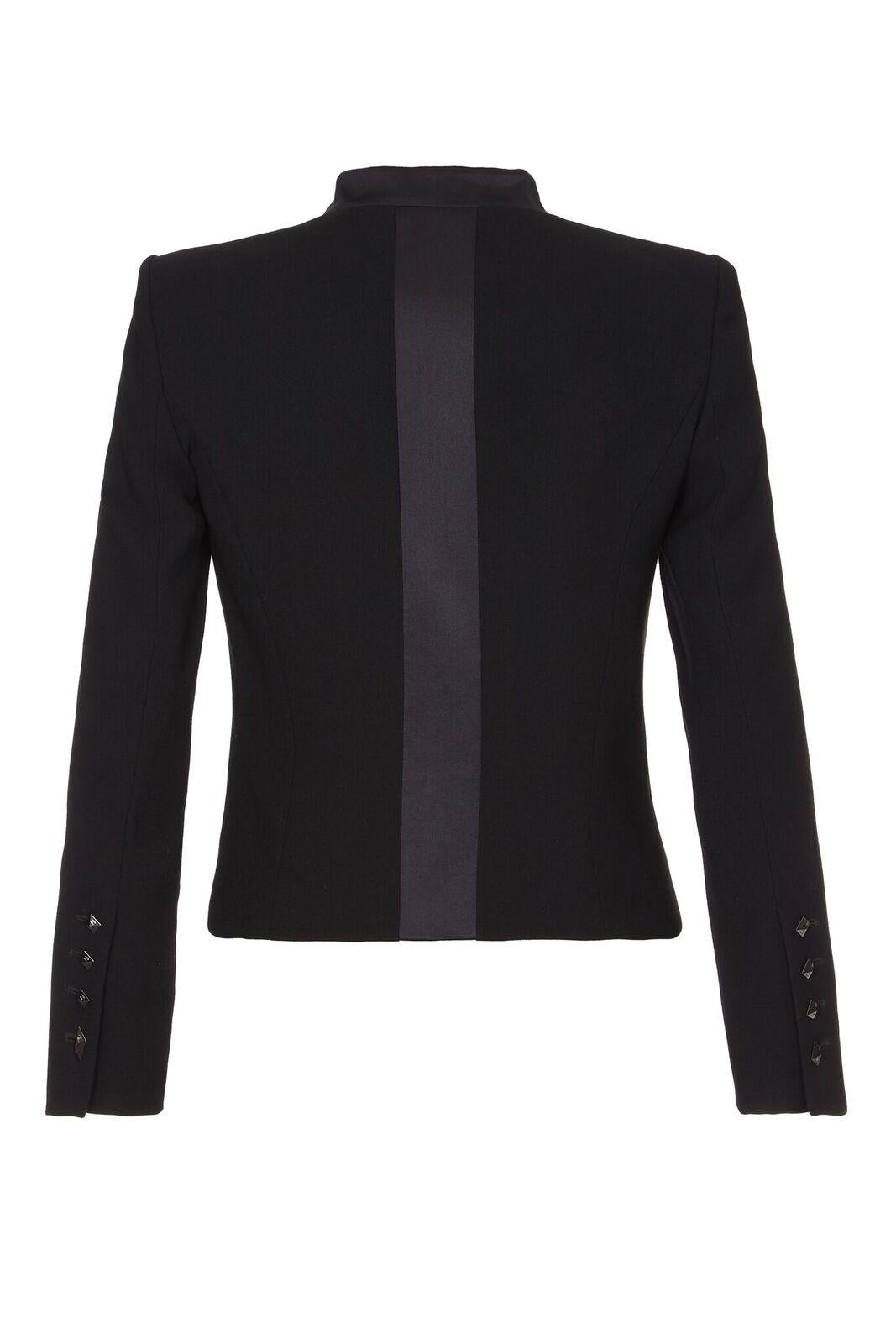 This Chanel black silk crepe jacket circa 2003 is of exceptional quality. The modernity and simplicity of the line is sharp and chic as well as feminine. The flat lapel is of silk satin to contrast with the mat texture of the lightweight crepe and