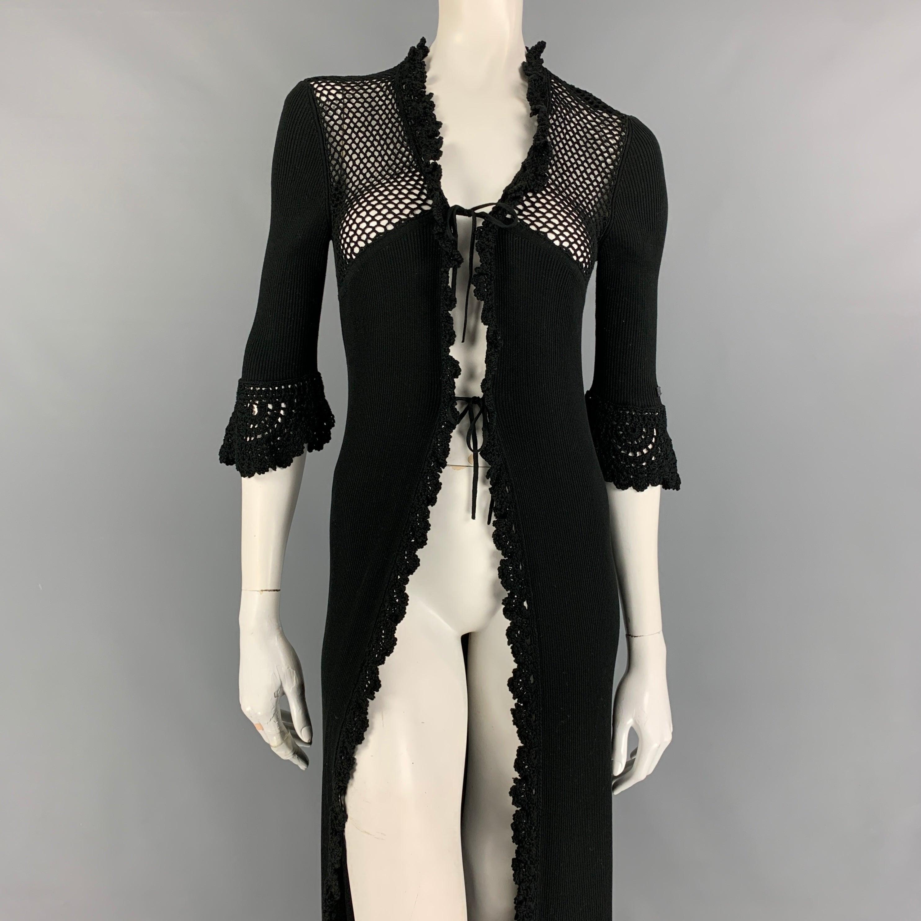 CHANEL 2003 cardigan comes in a black knitted cotton featuring crochet details, 3/4 sleeves, and a front double tie closure. Made in Italy.
Very Good Pre-Owned Condition. 

Marked:   42 

Measurements: 
 
Shoulder: 15.5 inches  Bust: 30 inches 