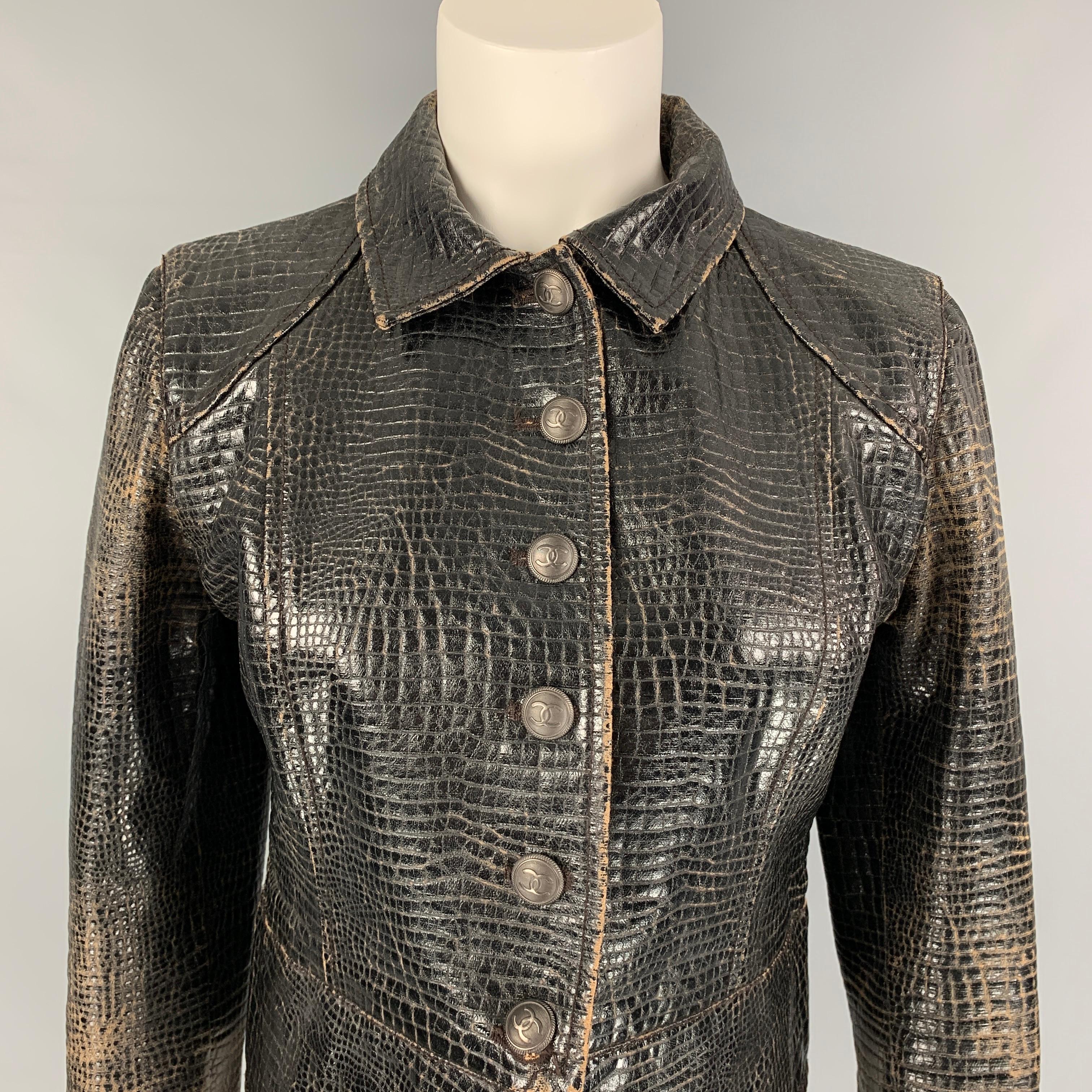 CHANEL 2003 jacket comes in a black distressed embossed cotton / spandex with a full liner featuring a biker style, logo button details, flap pockets, spread collar, and a buttoned closure. Made in Italy. 

Very Good Pre-Owned Condition.
Marked: