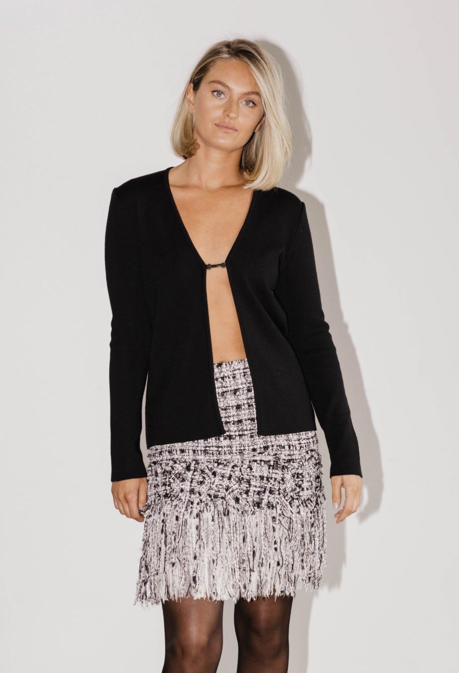 A timeless piece from Chanel’s coveted 2004 collection, this tweed skirt epitomises the maison’s signature craftsmanship and attention to detail. Woven in a classic monochrome palette, the textured tweed fabric is both chic and versatile. The