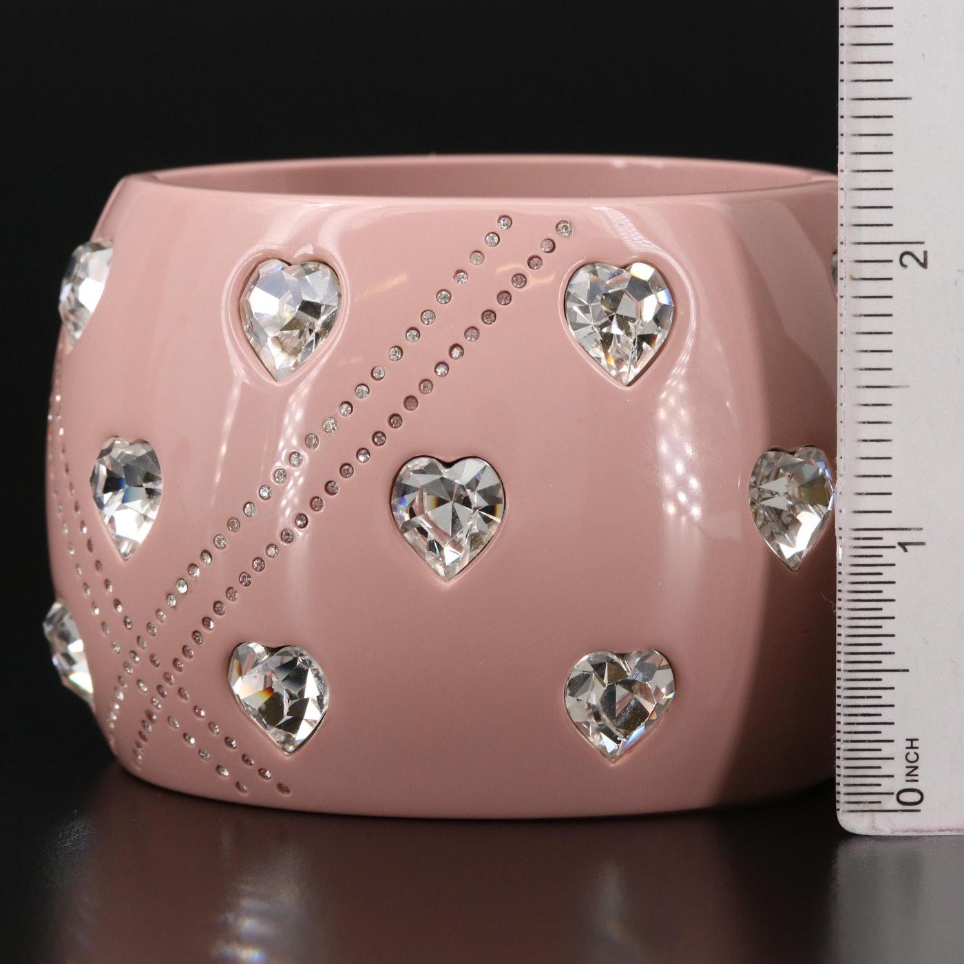 Chanel 2004 pale dusty rose acrylic clamper cuff with inlaid faceted silver-backed heart crystals, a geometric design featuring double rows of intersecting inlaid mini-crystals and two CC logos inlaid with mini-crystals at the bottom of each side.