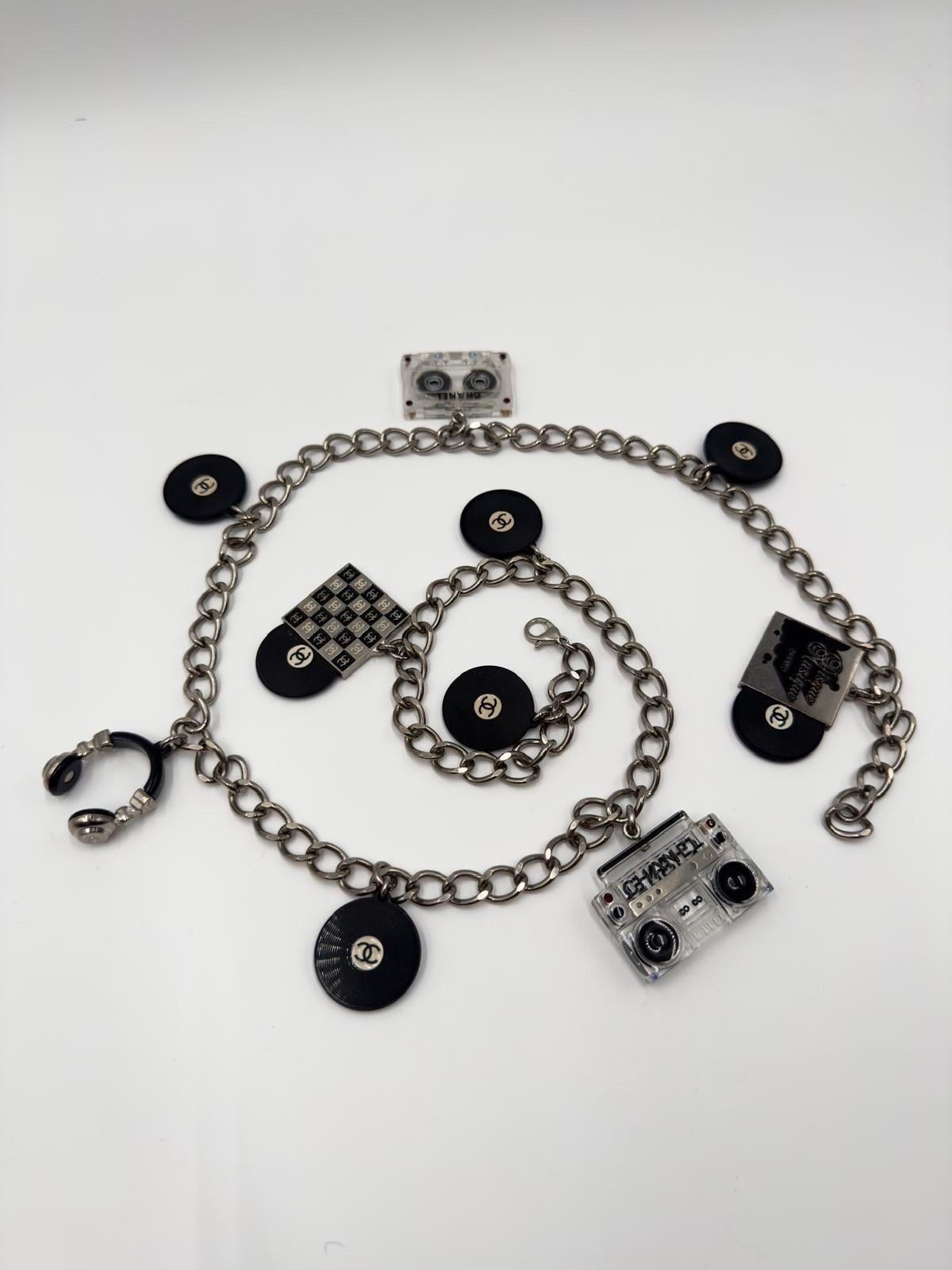 This exceptionally rare Chanel charm belt necklace from the 2004 collection is a true collector’s piece. Measuring 87 cm in length, it features music-inspired charms including vinyl records, a cassette tape, a checkerboard, and a boombox—perfectly