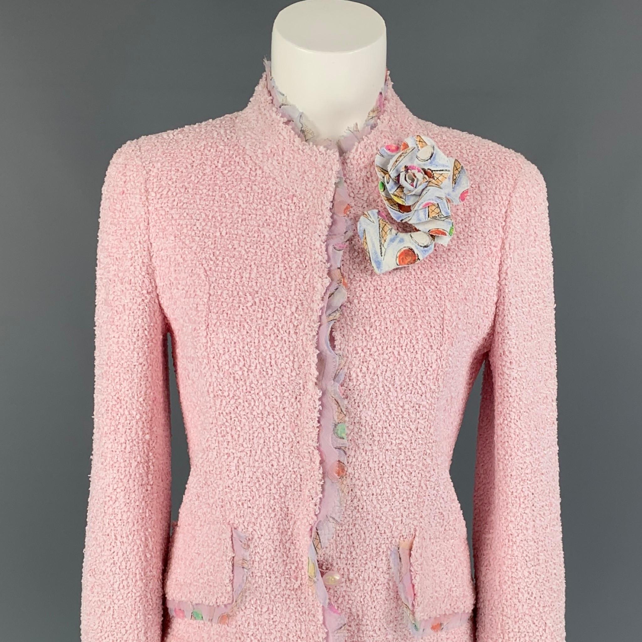 CHANEL 2004 jacket comes in a pink boucle polyamide blend with a full print liner featuring a heart & floral pin, logo buttons, silk ice cream trim, flap pockets, and a buttoned closure. Made in France. 

Excellent Pre-Owned Condition.
Marked: