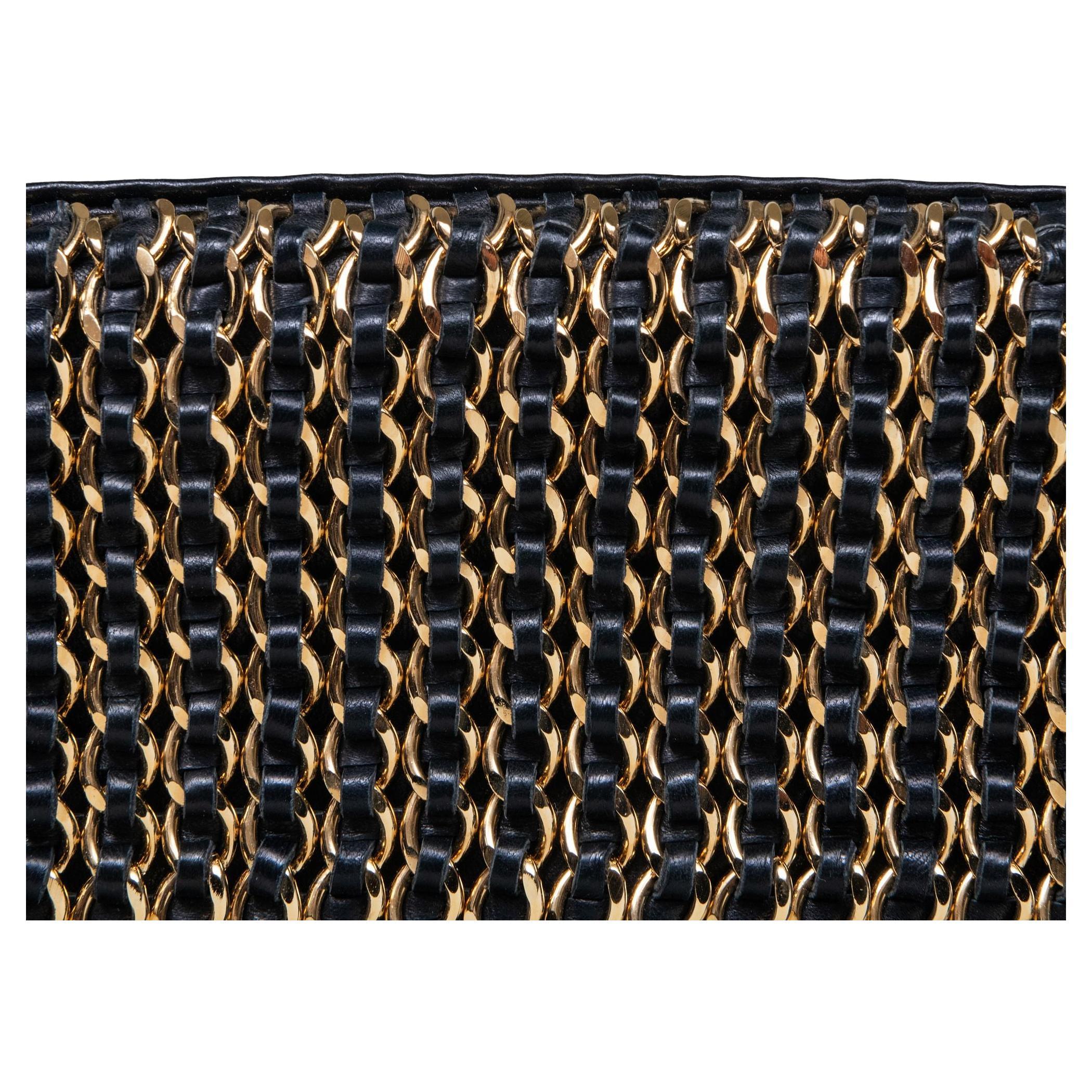 Chanel Vintage Black Lambskin Chain-Embellished Clutch Flap Bag

Year: 2003-2004 {Vintage 20 Years}

Gold hardware
Dual gathered shoulder strap with knot accent
Chanel embellished chain-link accents at flap
Tonal logo jacquard lining 
Snap closure