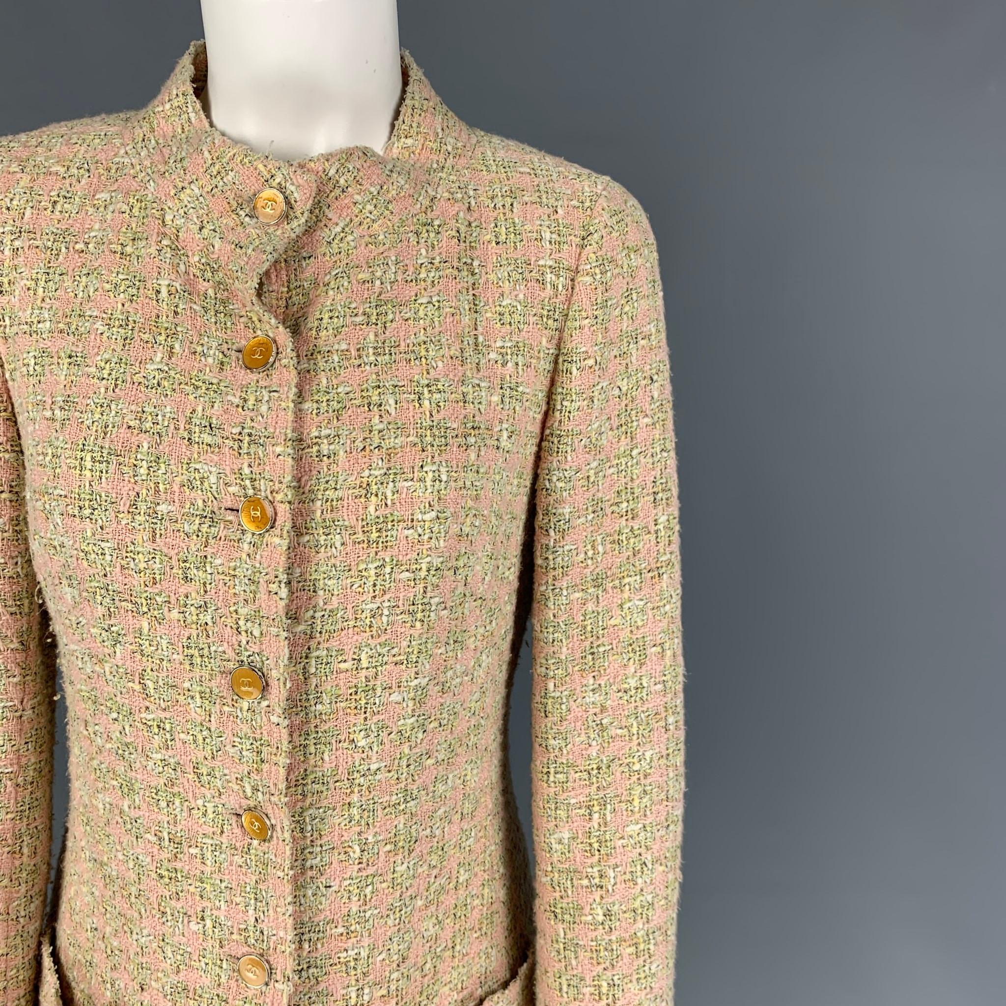 CHANEL 2005 coat comes in a light green & pink boucle houndstooth cotton blend featuring gold tone logo buttons, patch pocket, back buttoned single vent, and buttoned cuffs. Made in France. 

Very Good Pre-Owned Condition. Sleeves have been