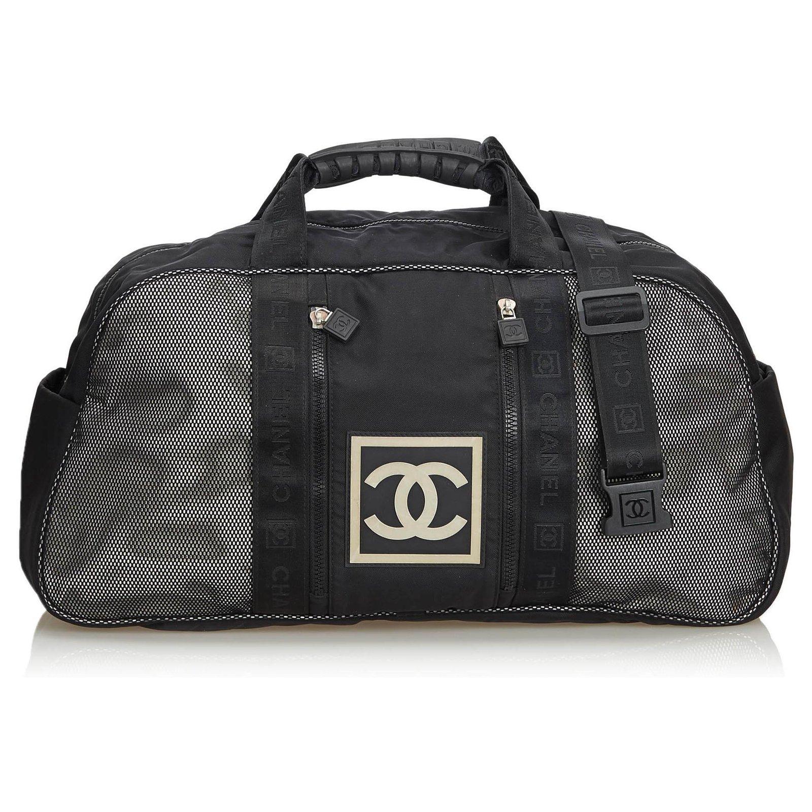 Chanel 2005 Vintage Black CC Nylon Sport Mesh Large Gym Travel Duffle Bag 

Rubber CC Logo at front
Nylon body with rubber trim
Front exterior zip pockets
Rolled handles
Detachable strap
Top zip closure
Interior zippered pocket

Made in Italy
