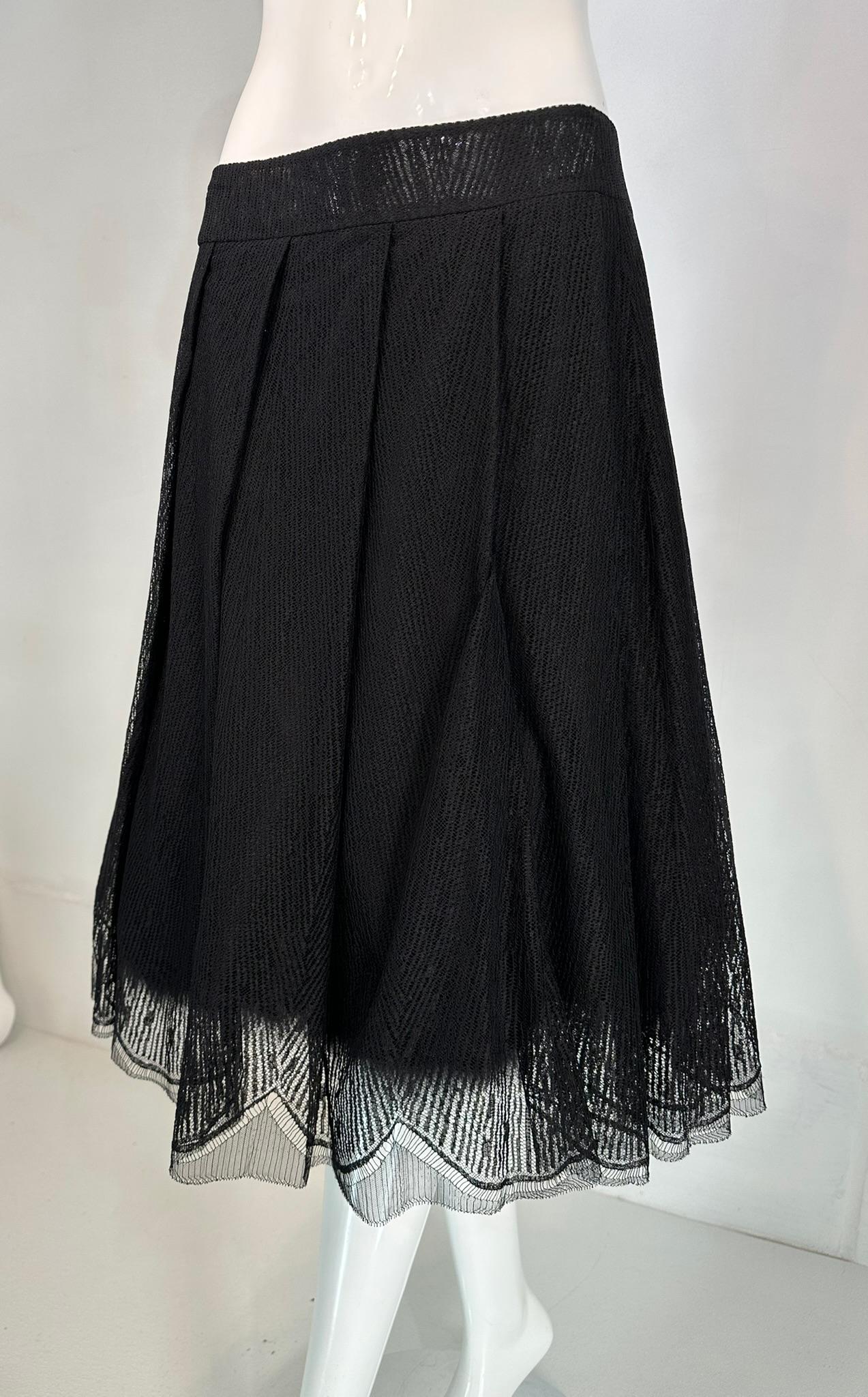 Chanel 2005A layered black tulle and silk pleated skirt with ostrich feather 40 marked size 40. Shaped yoke waist band, sits below the natural waistline skirt has open pleats, the skirt is layered. The outer layer is black lacy edge tulle, there are