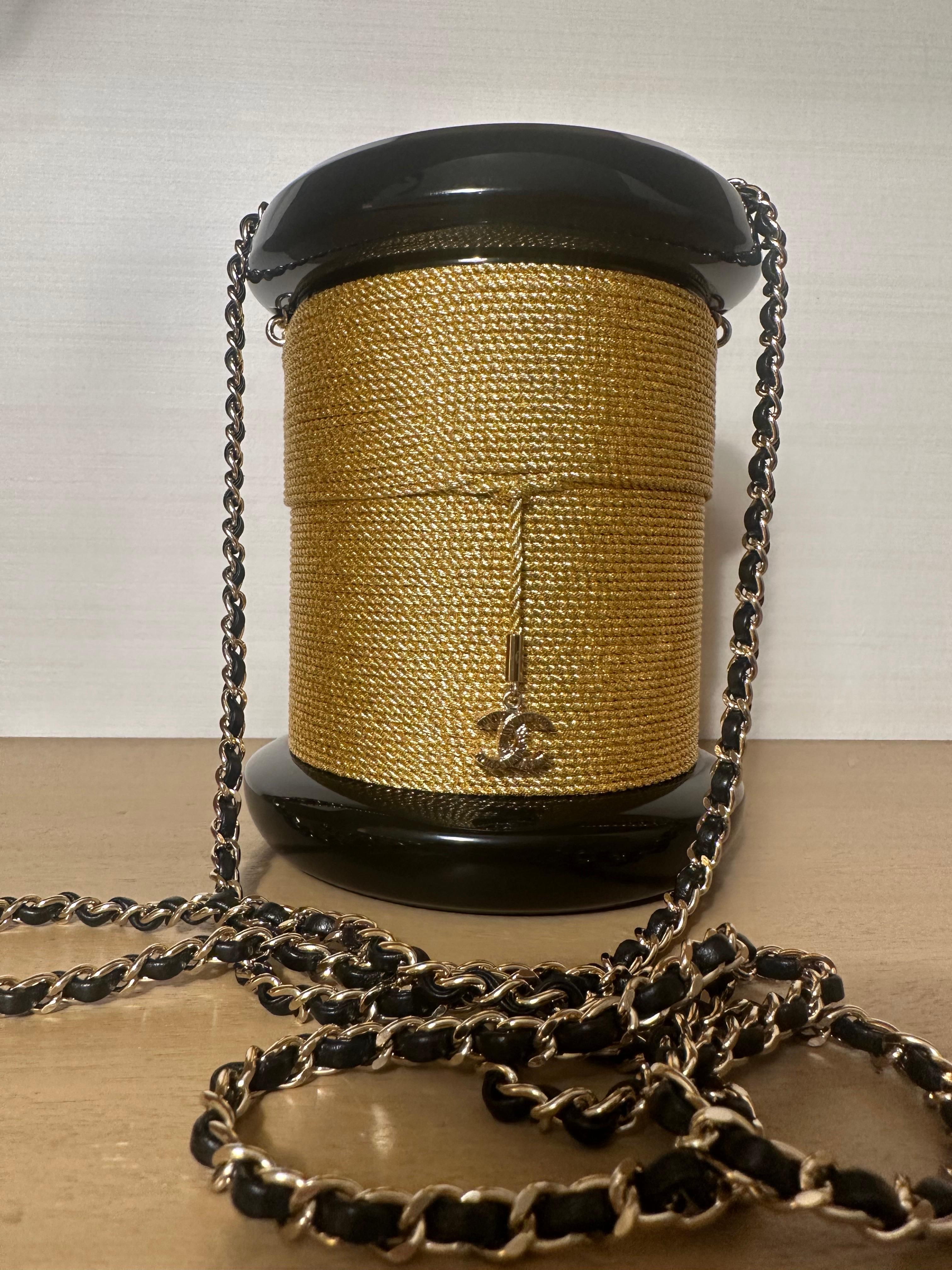 Chanel 2006 Limited Edition Runway Gold. & Black Lucite Spool Evening Bag 

Very rare collectors item. In very good condition - some hairline scratches on hardware. sold with dustbag only.

12 w x 16 h x 12 d cm
