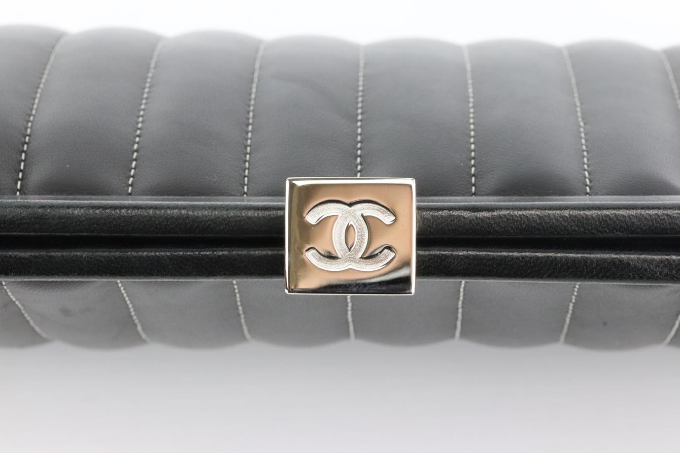 Made in France, this beautiful 2006 Chanel ‘Mademoiselle Ligne' clutch bag has been made from black lambskin leather exterior, this piece is decorated with Chanel's silver-tone CC logo clasp on the top and finished with white contrast stitching to