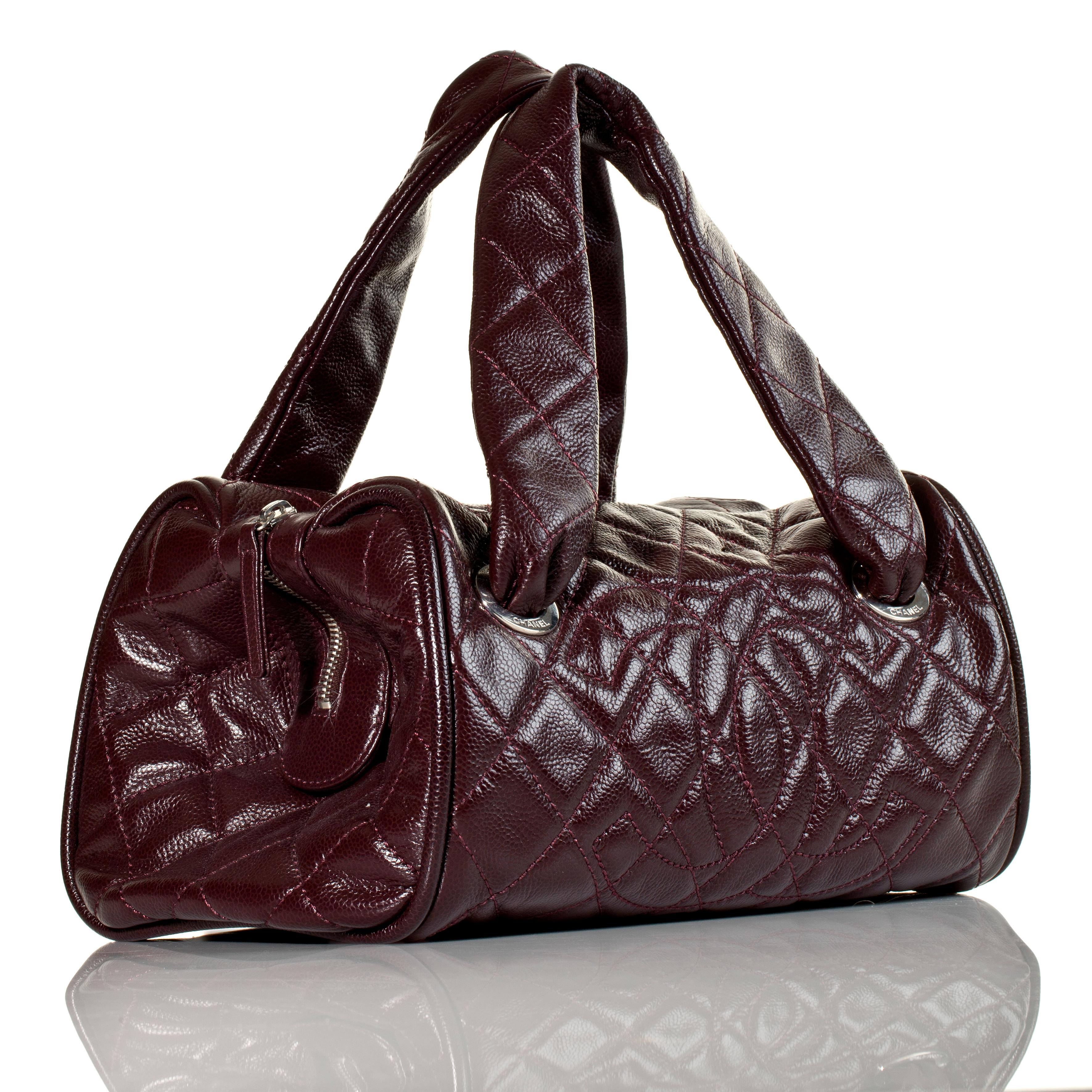 Chanel 2006 Quilted Caviar Burgundy CC Kelly Top Handle Boston Satchel Tote Bag 

Year: 2006 {Vintage 18 Year}

Silver hardware
Stitched CC Logo at front 
Dual top handles
Zip closure at top
Burgundy leather lining 
Three interior pockets
Protective
