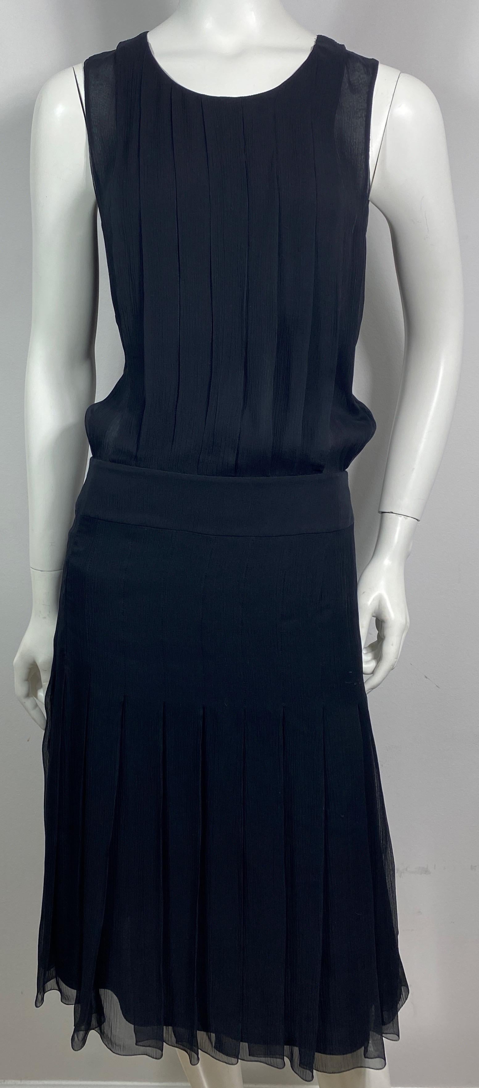 Chanel 2006C Black Silk Chiffon Sleeveless Dress-Size 40 This sleeveless black silk chiffon dress is from the 2006 Cruise Collection. The dress is made of a silk chiffon and is lined in a black silk, the sleeveless top is a pleated blousy cut that