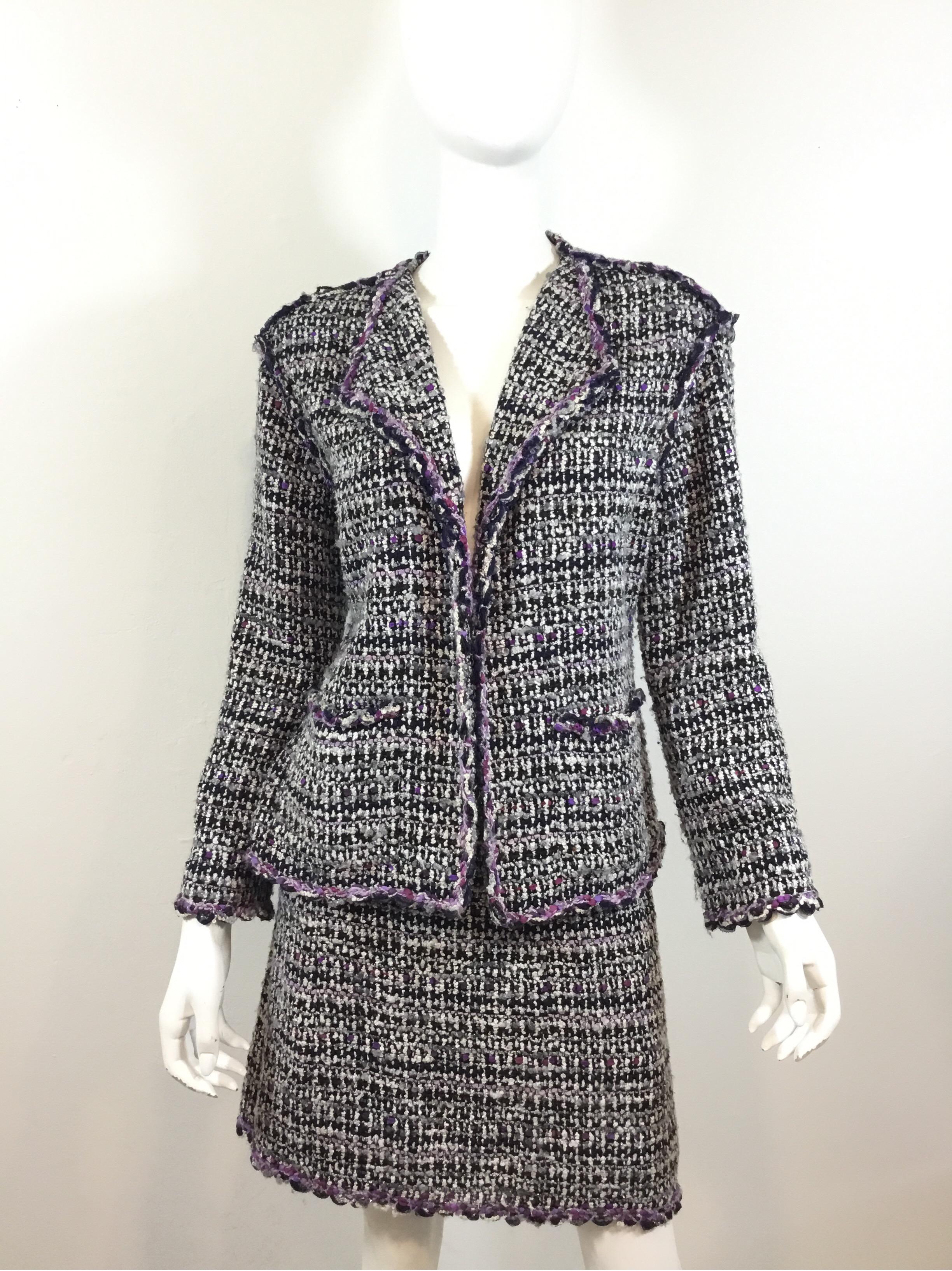 Chanel purple/black fantasy Tweed jacket and skirt suit— Jacket is a size 40, skirt is a size 42. Made in France.

Jacket has an open front, two patch pockets, and a full lining.
Skirt is fully lined and has a back zipper closure.

Jacket: bust 40”,