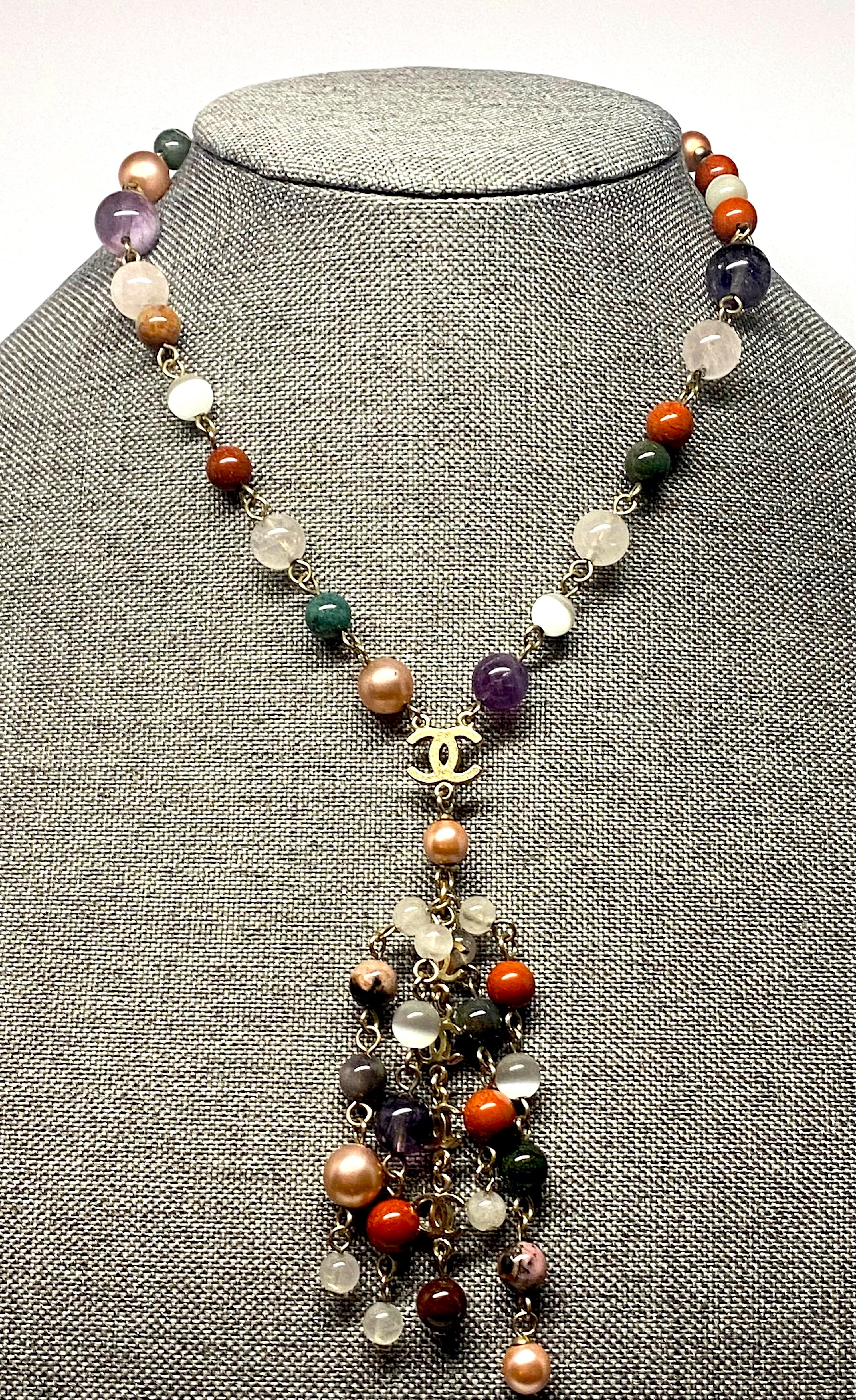 A lovely and easy to wear Chanel bead necklace from the 2007 cruise collection. The necklace is 17.25 inches long of semi precious stone beads connected by satin gold color rings. The various size beads are transparent pale rose quartz, terra cotta