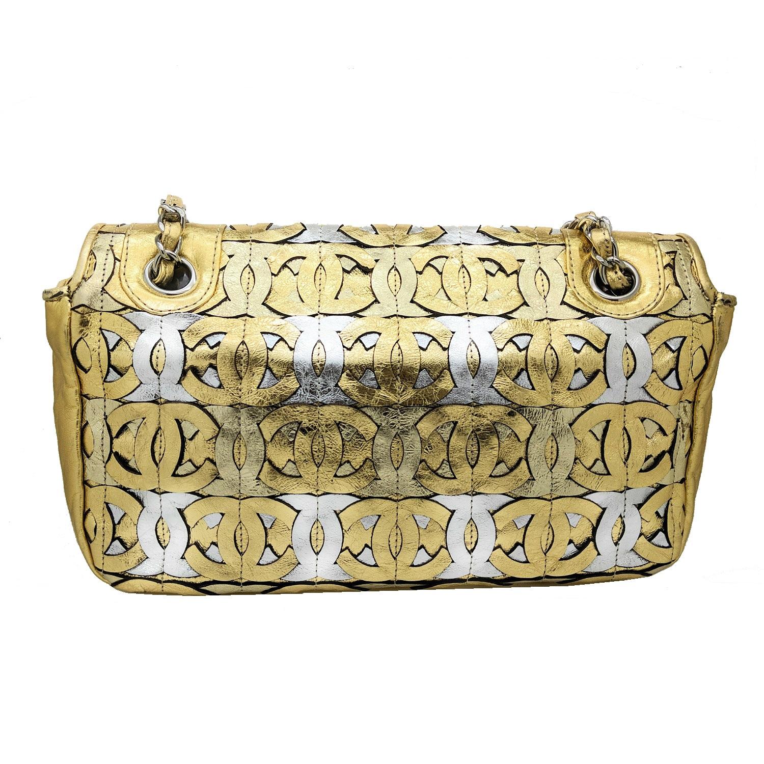 This stunning shoulder flap bag is crafted of a pattern of collaged gold and silver calfskin crackled leather Chanel CC logos. The bag features silver chain link leather threaded shoulder straps and a border trim of gold leather with a CC magnetic