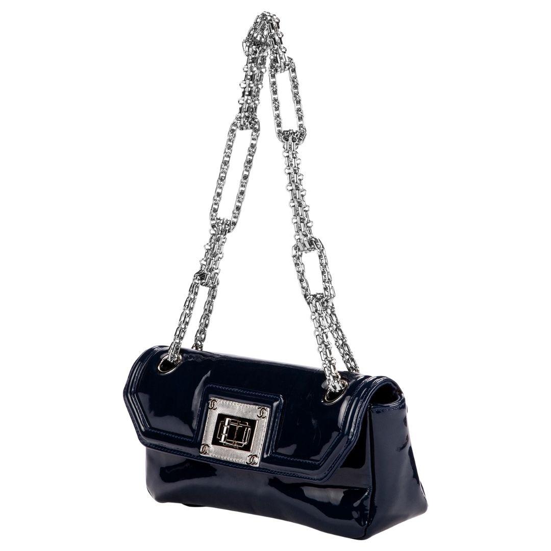 Not your average Chanel. So unique and funky! e are in love with the navy blue patent leather, silver hardware, and the chunky silver chain link strap. The twist lock opens to a silver metallic interior with a single zipper