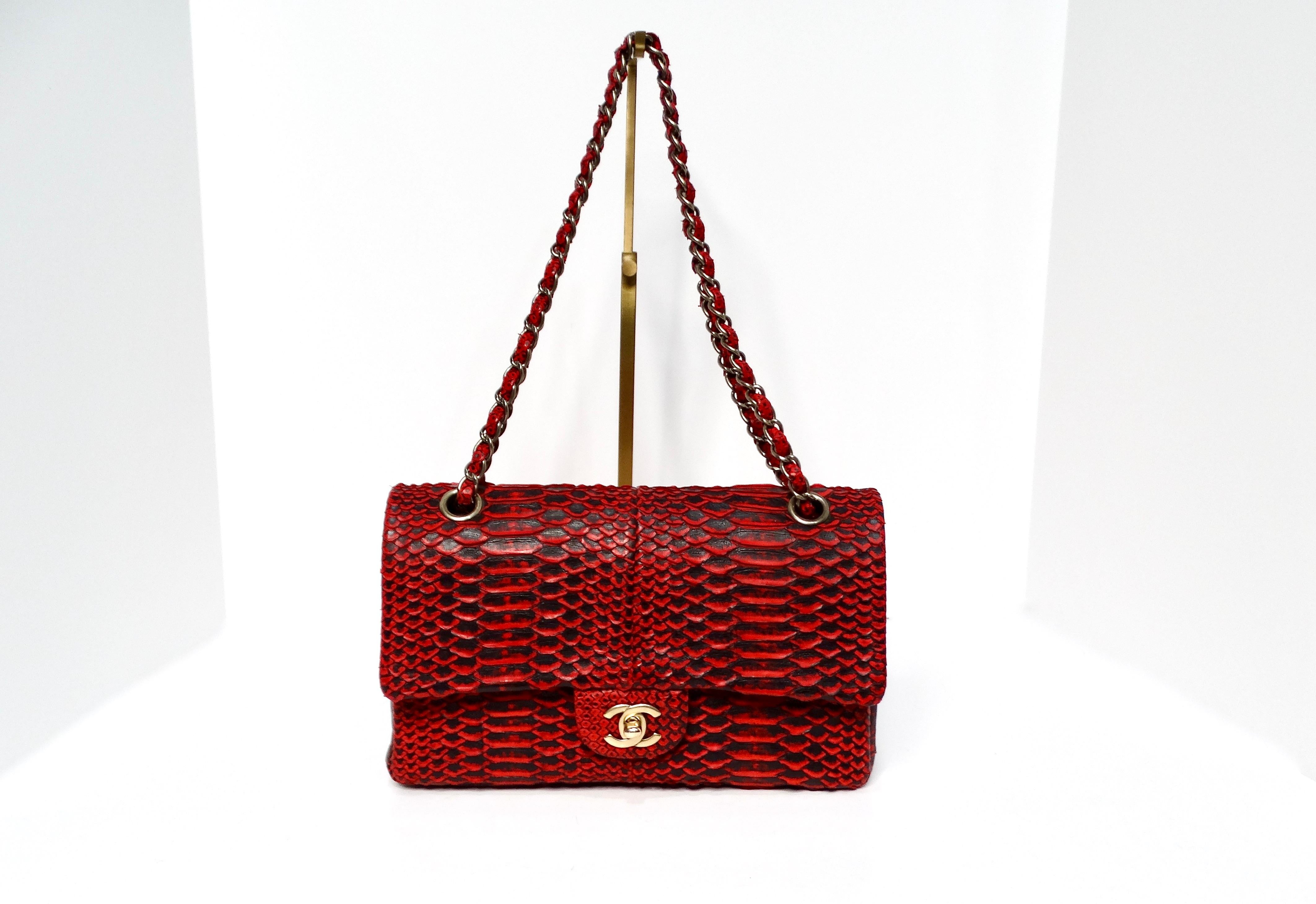 The Chanel 2009-10 Red Python Small Double-Flap Bag is a stunning piece that embodies luxury, sophistication, and rarity. Crafted from striking red and black python leather, this bag is not only a functional accessory to fit your essentials; it’s