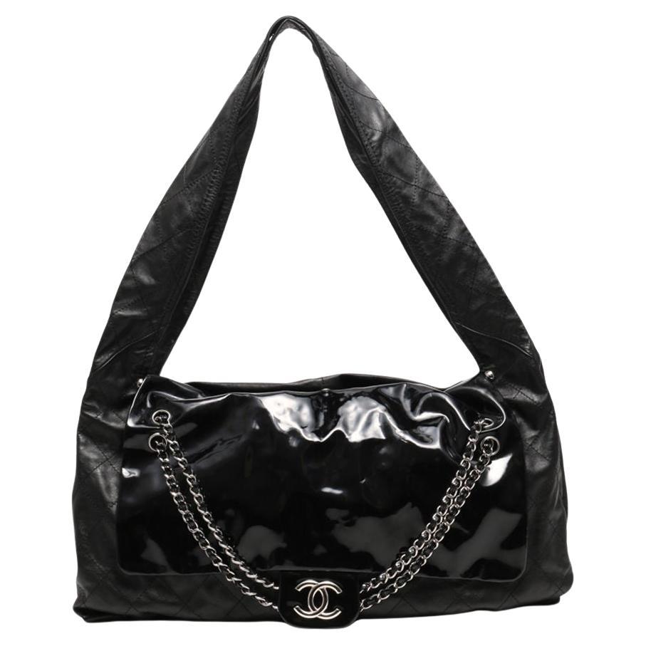 Chanel Borsa oversize XL in vernice e pelle trapuntata Tote con patta a tracolla 

Anno: 2008-2009 {Vintage 16 anni}

Ferramenta in argento
Pelle di vernice nera e pelle di vitello trapuntata
Chiusura magnetica
Catena classica in vernice