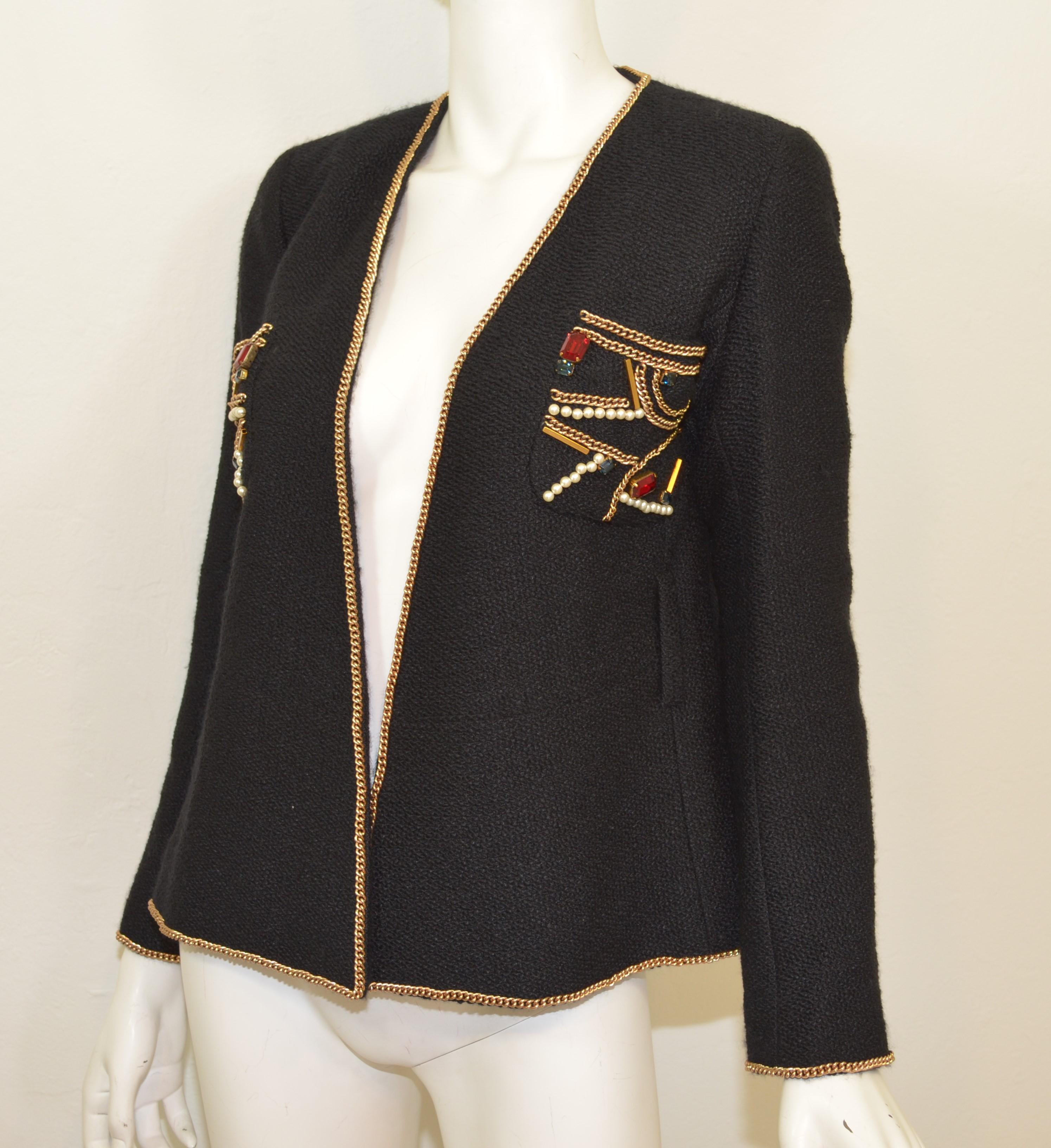 Chanel 2009 Moscow Collection jacket is featured in a black knit tweed with embellished patch pockets and chain trimming. Jacket is a size 40, composed with wool, alpaca, and nylon blend with silk lining. Made in France.

Measurements:

Bust