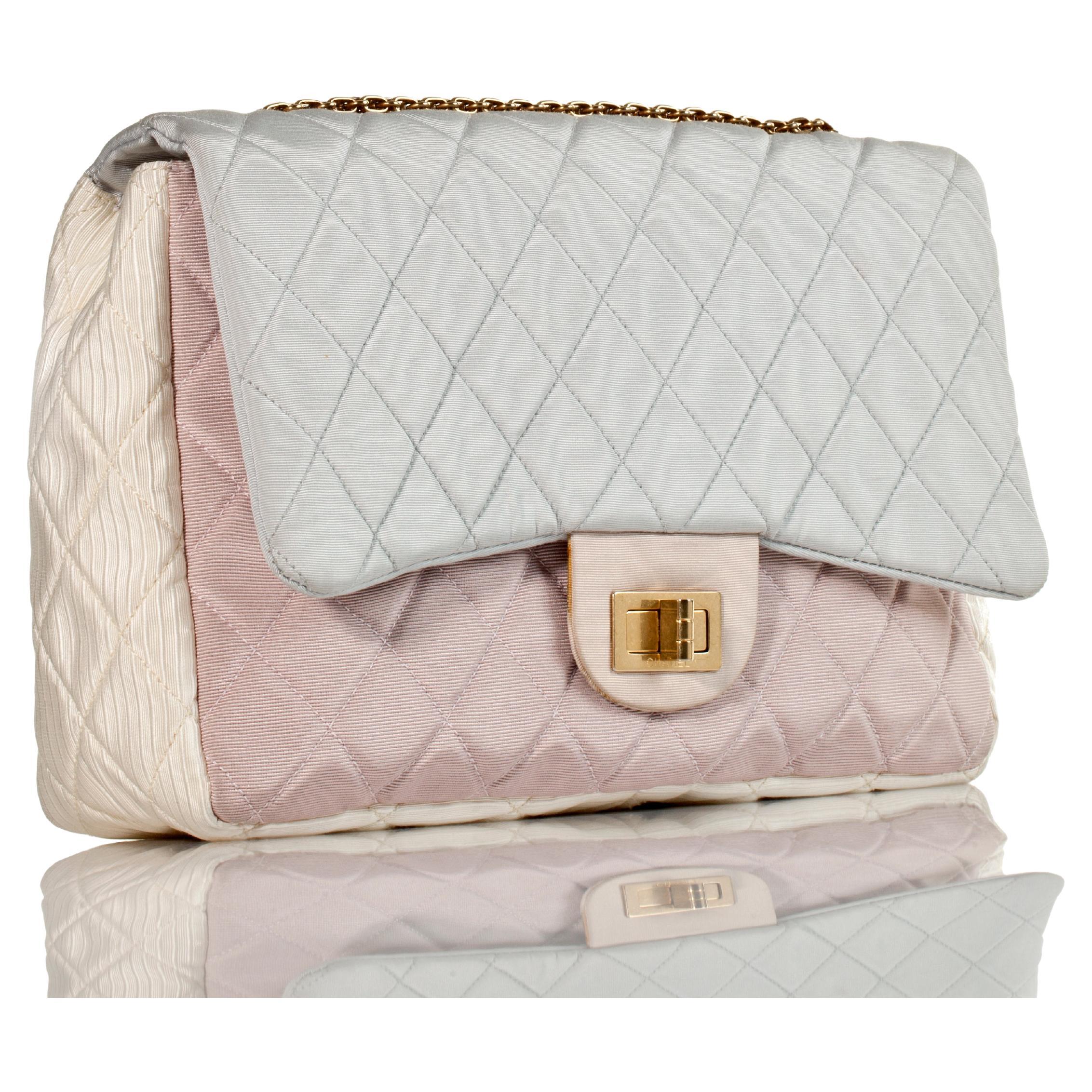 Chanel Resort Pastel Multicolor Satin Nylon Reissue Flap Bag 

2009 {Vintage 15 Years}

Gold bijoux chain
Pastel hues: blue, pink and yellow 
Adjustable shoulder strap and back exterior slip pocket
Ivory fabric interior with one slip and one