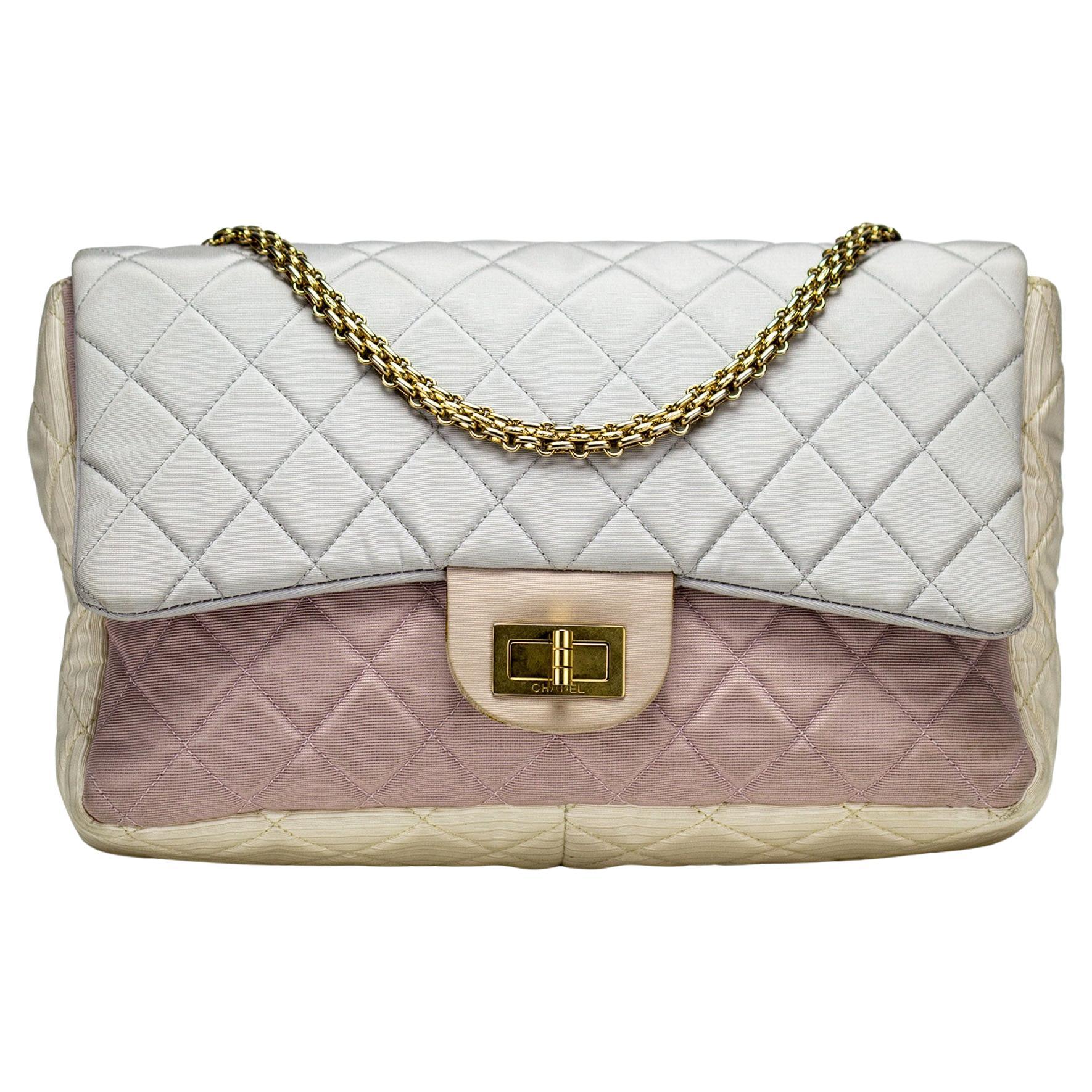 Chanel Resort Pastel Multicolor Satin Nylon Reissue Flap Bag 

2009 {Vintage 15 Years}

Gold bijoux chain
Pastel hues: blue, pink and yellow 
Adjustable shoulder strap and back exterior slip pocket
Ivory fabric interior with one slip and one
