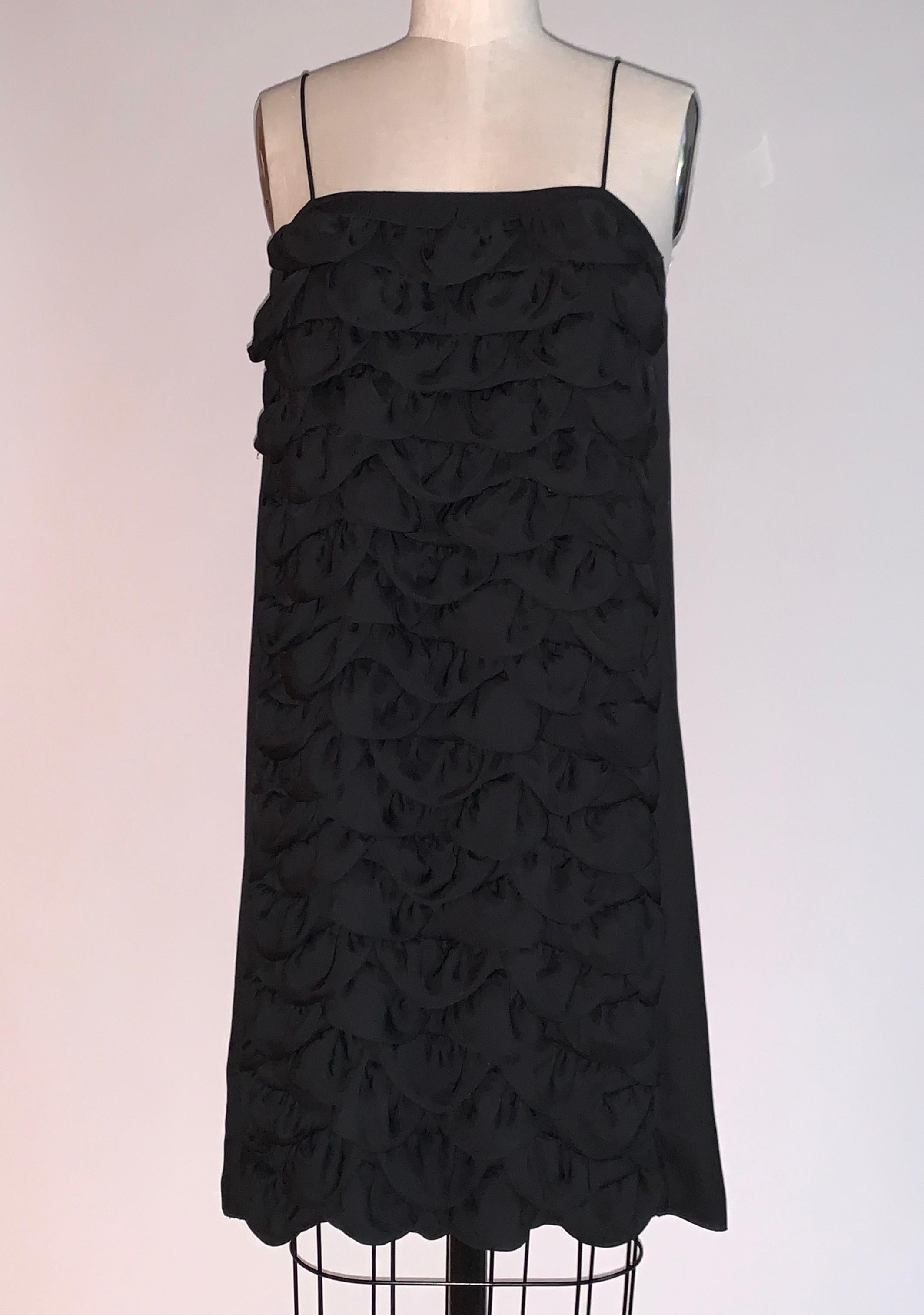 Chanel black sleeveless dress with tiers of petal shaped fabric at front. From the Cruise 2009 collection. Metal CC logo at back top. Lightweight fabric, great as a beach or pool coverup or worn as a casual dress. No closure, pulls on overhead.