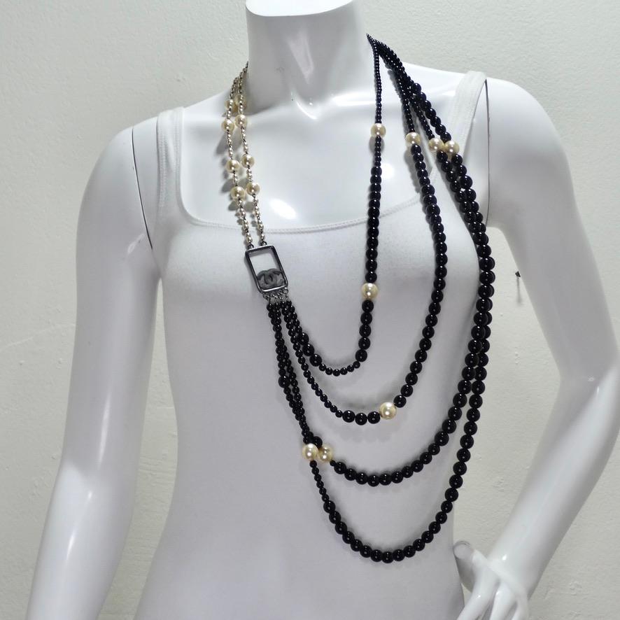 Do not miss out on this absolutely breathtaking Chanel multi strand beaded necklace circa 2010! Cascading strands of black beads at different lengths are joined by an arrangement of pearl beads and silver hardware with two signature Chanel
