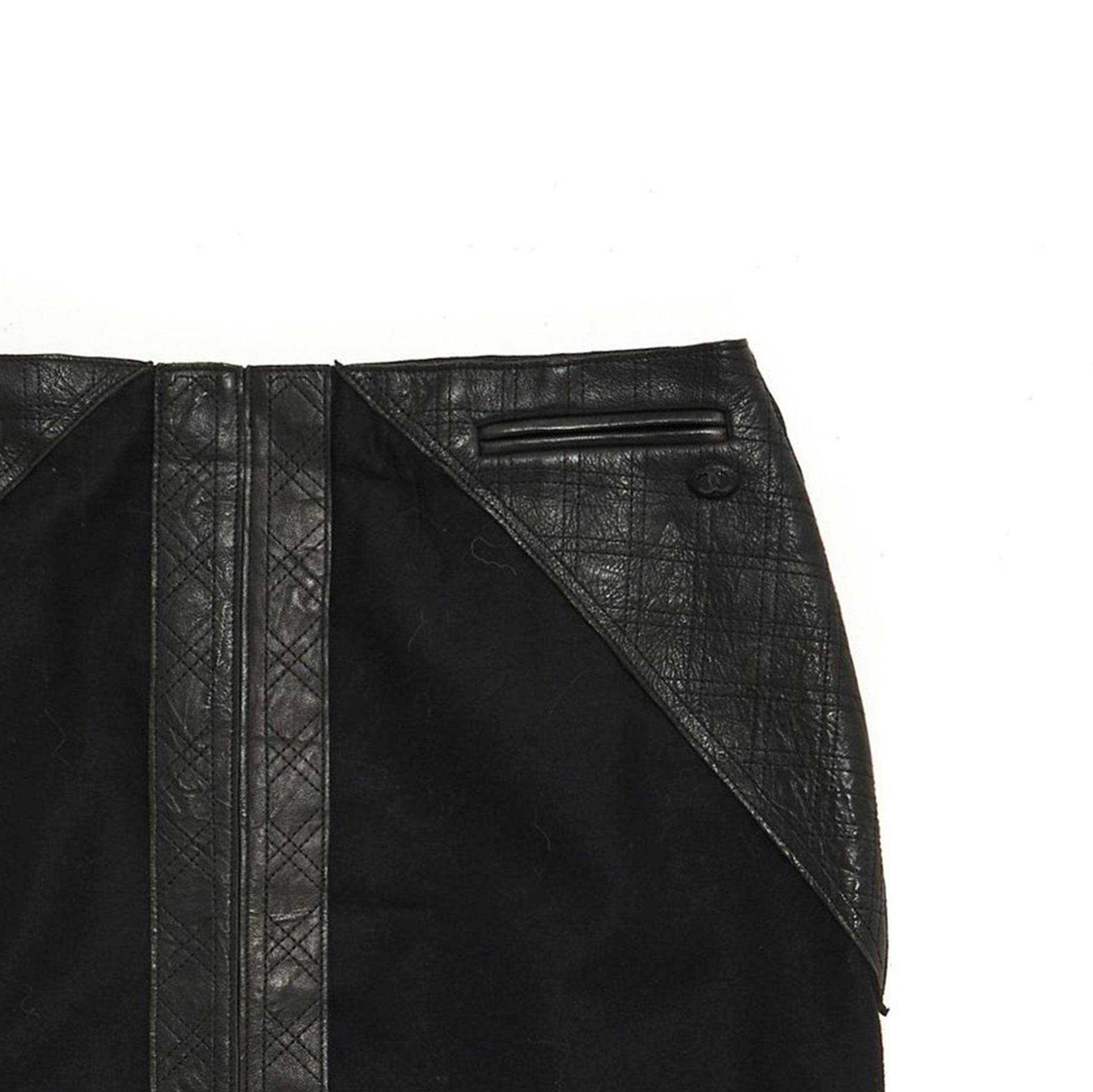 Chanel mid-length skirt in black wool and cashmere cloth decorated with black quilted leather on the hips and in front, along the central slit, 2 slit pockets (always closed), black silk lining. Size 38FR, waist 37 cm, length 57 cm. The skirt is in