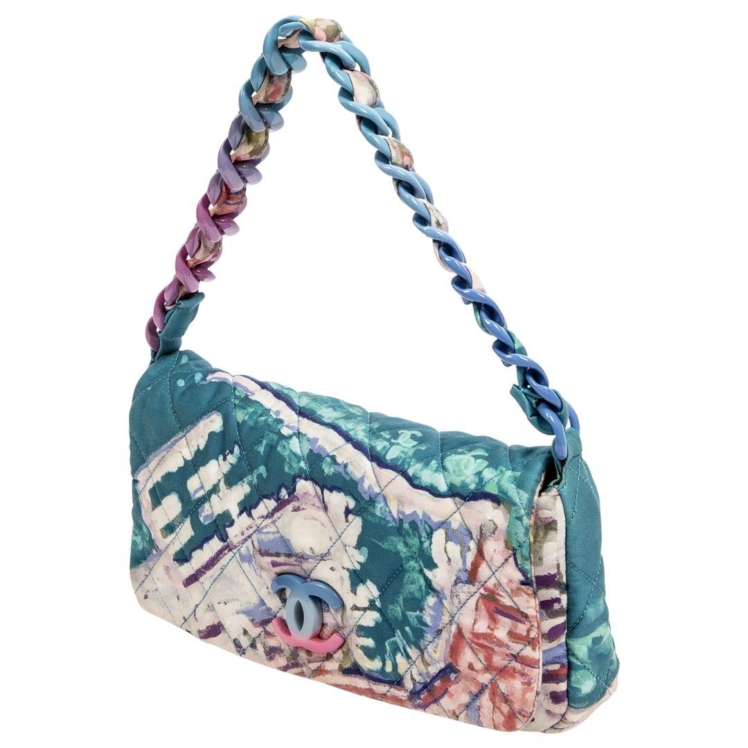 You make me happy when skies are grey. This 2010-2011 abstract watercolor beauty is crafted in multicolor quilted nylon canvas, a multicolor CC logo to the front, and a multicolor single shoulder strap. The magnetic snap closure opens to a canvas