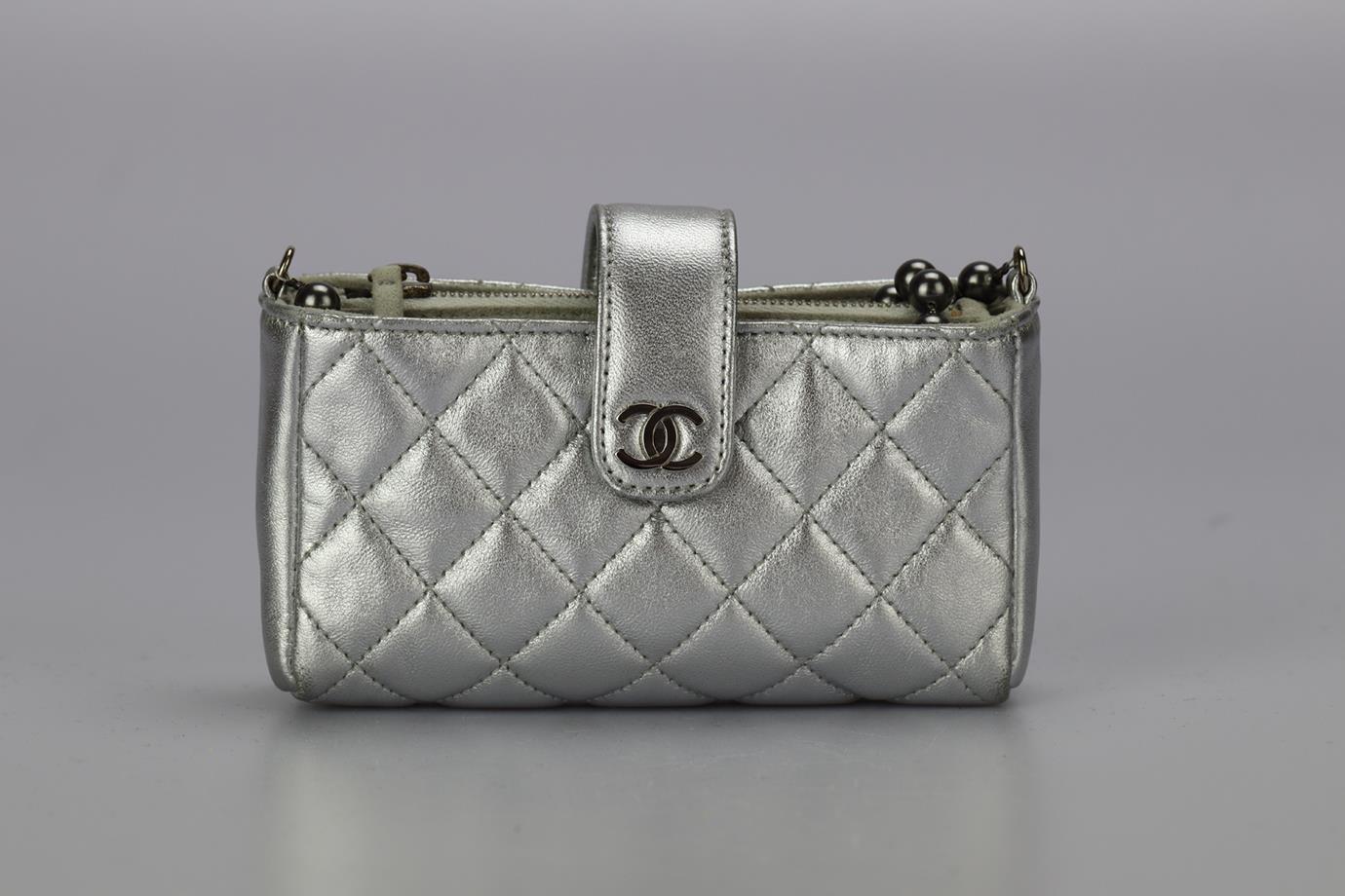 Chanel 2010 O-phone Holder Quilted Leather Shoulder Bag. Metallic. Magnetic fastening - Front. Does not come with - dustbag or box. Height: 2.6 in. Width: 5.2 in. Depth: 1.4 in. Strap drop: 25 in. Condition: Used. Light scuffing to exterior material