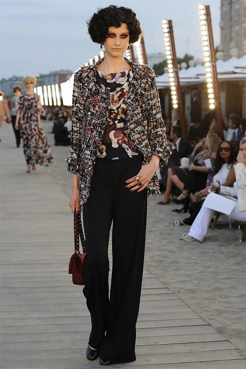 Chanel 2010 Resort Runway Sheer Purple Silk Floral CC Top.  From the 2010 cruise runway collection. Sheer silk top with flutter sleeves, ruched centre front waist, red enamel buttons at back and top shoulders.  Marked size FR38 (USA 6). Will also