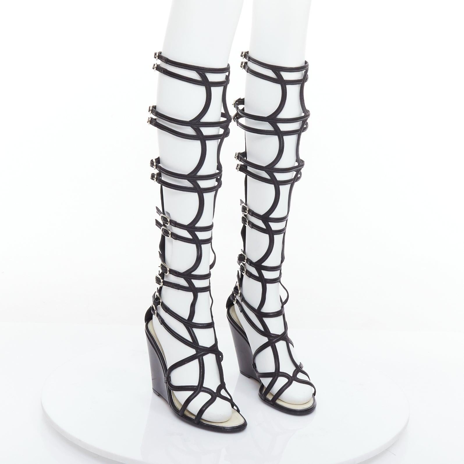 CHANEL 2010 Runway black leather gladiator wedge sandals EU38
Reference: NKLL/A00351
Brand: Chanel
Designer: Karl Lagerfeld
Collection: Cruise 2010 - Runway
Material: Leather
Color: Black, Silver
Pattern: Solid
Closure: Zip
Lining: Grey