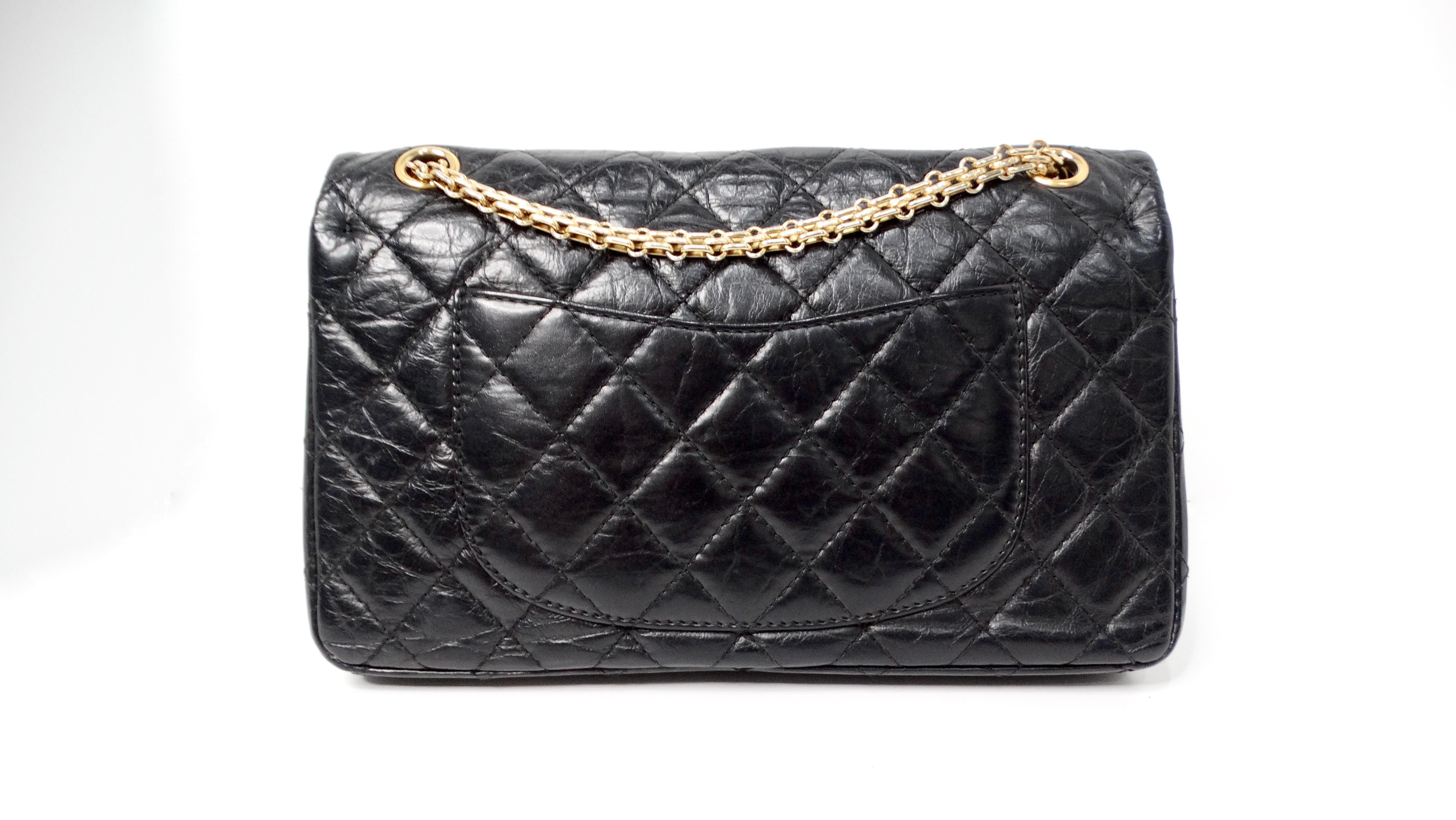 The Chanel 2011 Black Quilted Aged Calfskin 2.55 Reissue Medium Double Flap Handbag is a remarkable blend of timeless elegance and contemporary style. Crafted from aged calfskin leather, its soft texture exudes luxury, while the iconic quilted