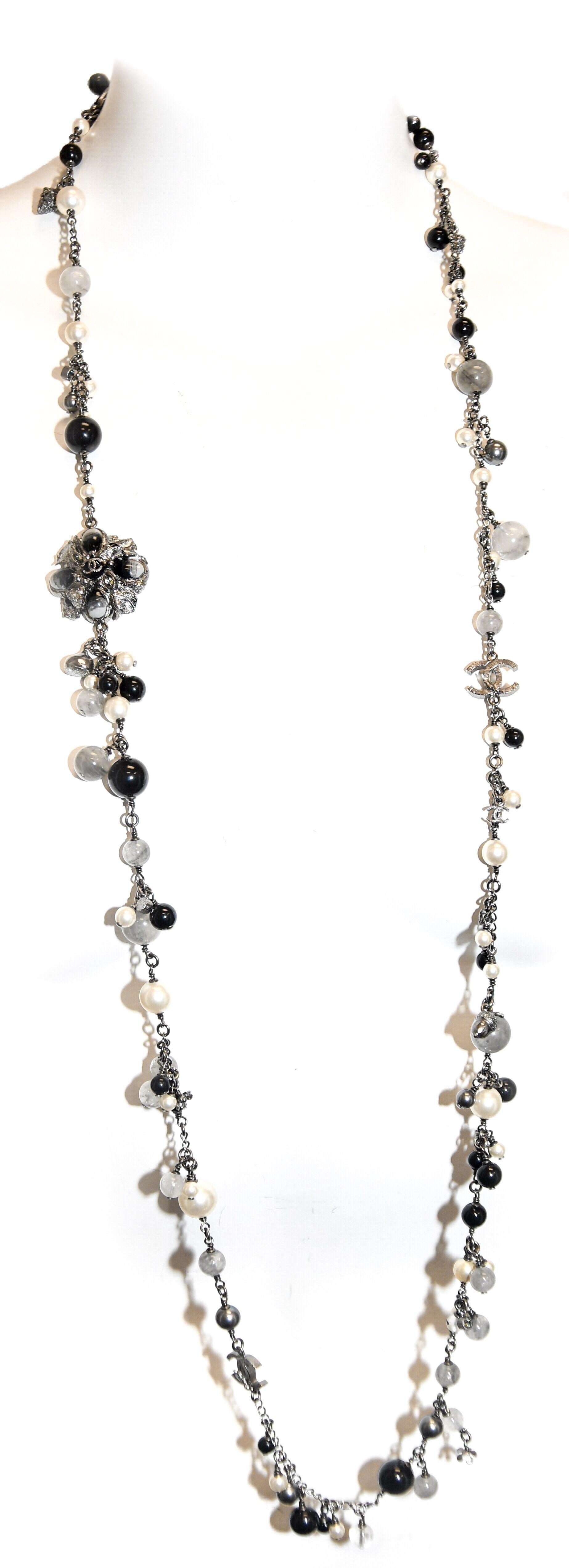 Instantly recognizable as an iconic Chanel necklace!  Pearls,  Onyx, Hematite and rutlilated quartz beads are only the beginning!
Ever familiar Camellia is adorned on each side with CC logo.  Bezel set crystals, acorns, CC logos and tiny flower