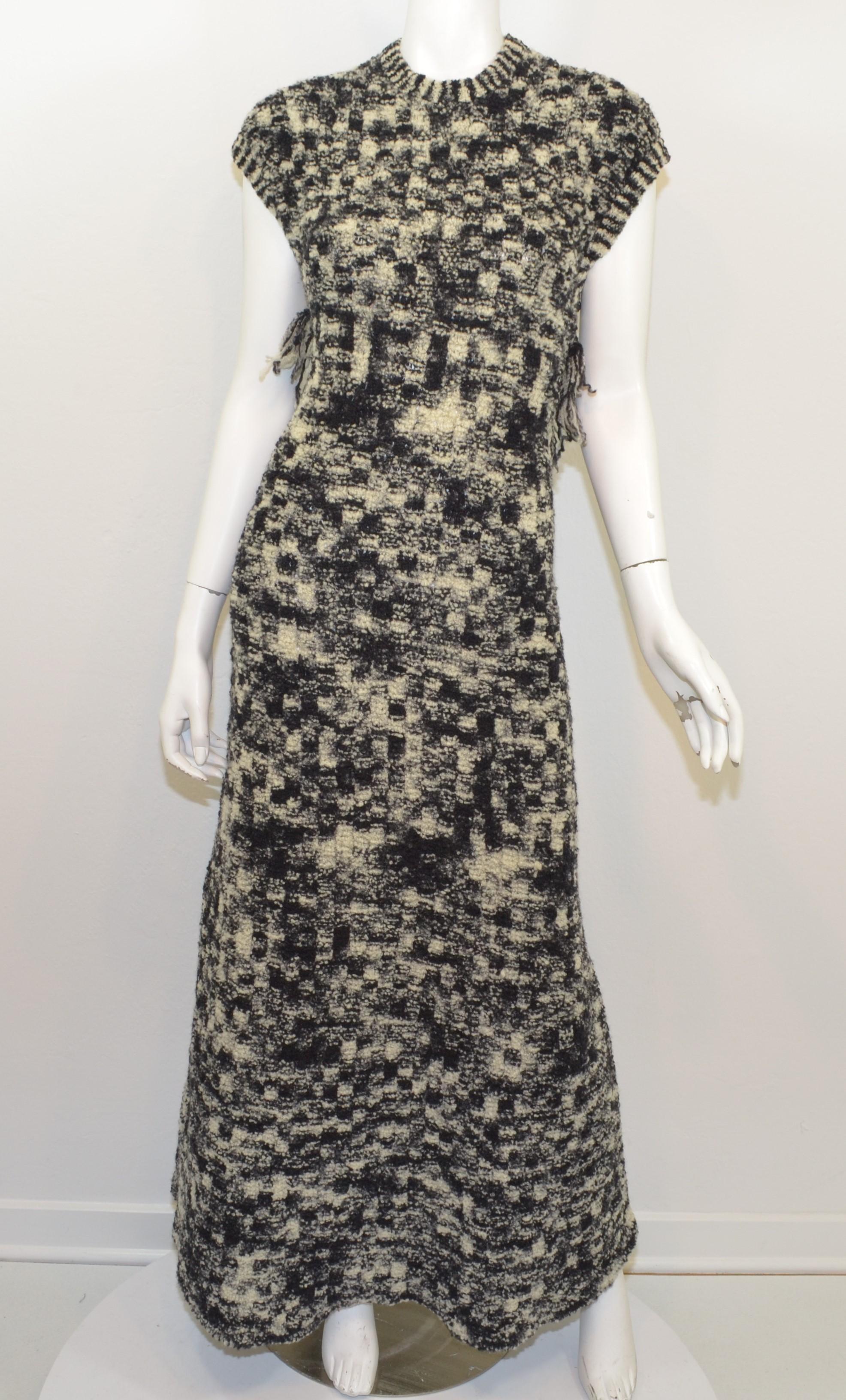 Chanel gown 2011 Fall/Winter Apocalyptic Collection -- featured in a black and cream boucle knit design with an X-crossover strap across the back with a single black Strass crystal encrusted button. Dress is composed with 90% wool / 10% nylon and is