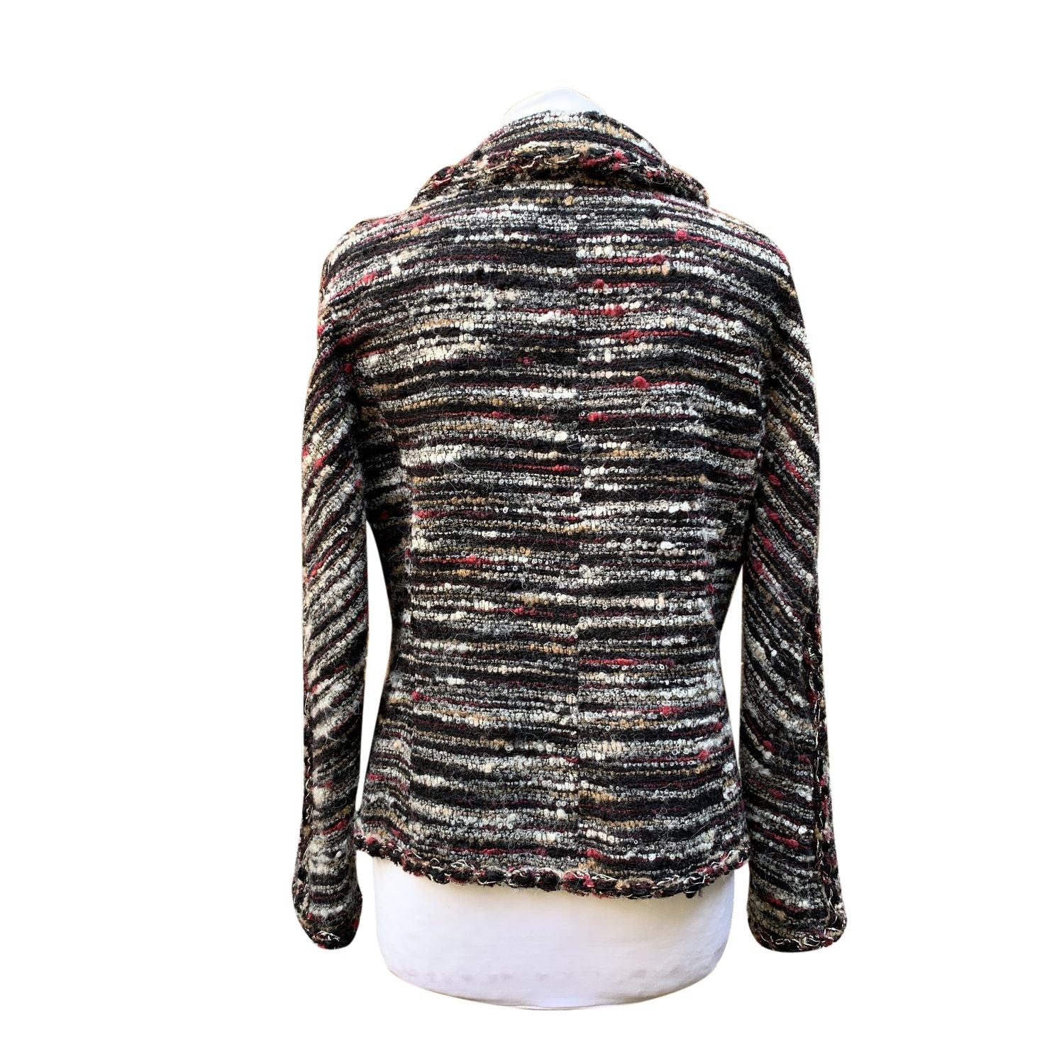 Introducing this Chanel Jacket Cardigan from the iconic 2011 Fall/Winter 'Paris - Byzance' Collection, a piece that embodies the perfect blend of timeless elegance and bold statement-making design. This cardigan, in classic black with a multicolored