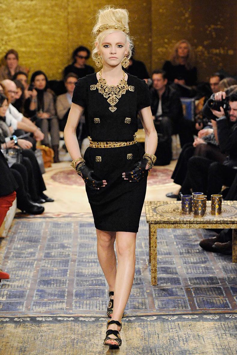 Chanel 2011 Pre-Fall Byzantine Collection Black Jewel Button Dress.  Classic wool knit jersey short sleeve dress with draped panel bodice, fitted skirt, hidden side pockets on seam.  Six large gold gripoix enamelled Byzance buttons.  Centre back